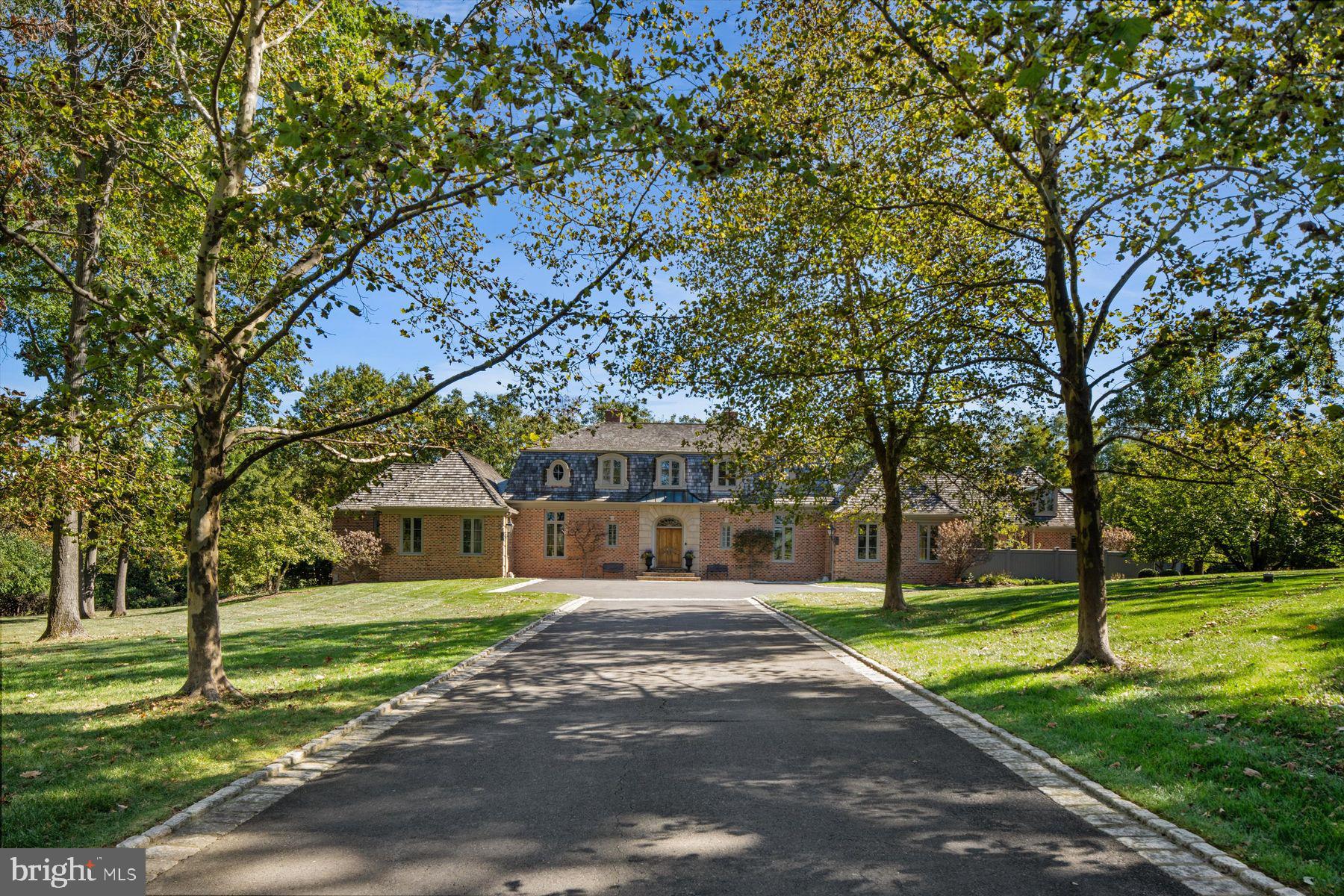 Nestled in Whitemarsh Township's prestigious Hunt Country on sought-after Sheaff Lane, this extraordinary custom estate offers the perfect balance of privacy, luxury, and comfort. Widely regarded as one of Montgomery County’s premier locations, the residence spans 7,000 square feet, thoughtfully designed by renowned architect Fred Bissinger and quality built by Parec. Situated on 3.3 acres of beautifully landscaped grounds and accessed via a gated entry, the property promises exclusivity and tranquility for its owners.
At the heart of the home is a state-of-the-art custom kitchen, expertly blending stunning design with superior functionality. Features include Village Hand Crafted Cabinetry, a six-burner dual-fuel Viking range, and two full-size Sub-Zero refrigerators. The well-appointed butler’s pantry adds convenience and style with its dedicated sink and additional custom cabinetry. Adjacent to the kitchen, a sun-drenched zen garden courtyard with raised garden beds and irrigation ensures a vibrant outdoor bounty throughout the year.
The gracious family room seamlessly connects to the kitchen and showcases handsome exposed beams and elegant built-ins, creating a welcoming setting for both daily living and gatherings. The formal dining room, living room, and study/library each feature their own fireplaces, offering inviting spaces for intimate gatherings or larger celebrations. Each of these rooms has direct access to the spacious rear blue stone patio, blending indoor comfort with exceptional outdoor living and entertaining space.
The primary suite serves as a luxurious retreat on the far wing of the main floor, complete with a spa-like marble bathroom. An additional ensuite bedroom on the same level is ideal for guests or multi-generational living. The main floor also includes a spacious laundry room and a mudroom equipped with a custom dog shower and custom cabinetry. Two powder rooms and numerous closets throughout the home provide functional convenience and generous storage.
Ascending to the upper level via antique handmade iron stair rails from the 19th century reveals two spacious bedroom suites, each with professional closet systems and custom window seats. The upper level also features a large gathering room, redesigned with built-in work stations and numerous built-ins —perfect for study, work, or relaxation. Above the garage, an au-pair suite or office includes a living area, bedroom, kitchenette, full private bathroom, hardwood flooring and separate entrance.
Outdoor living is elevated with over 3,000 square feet of blue stone patios, a state-of-the-art Aqua Bella swimming pool with spa and automatic cover (installed in 2016), a stone fire pit with natural gas, and breathtaking professional night scaping.
Additional highlights and modern comforts include custom built-ins throughout, arched doorways, an oversized three-car garage with epoxy floor, an additional one-car detached garage, a smart security CCTV system, cellular entry gate operations system, new well (installed in 2017), reverse osmosis water system, whole-house natural gas generator, and HVAC units with five zones (2017). These features ensure comfort and connectivity at every turn.
This unique property is being offered fully furnished. The location is A+ with offers easy access to fine dining, shopping, major routes including the PA Turnpike, Blue Route, and several regional train lines. Truly a special property not to be missed.