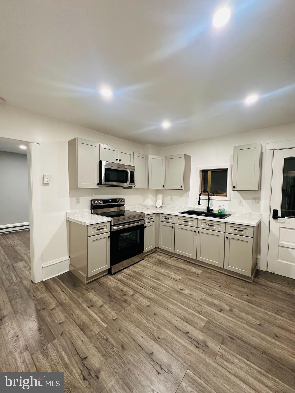 BACK ON THE MARKET!!! Don't miss your chance. Elegantly renovated Minersville raised ranch, showcasing recent upgrades to the kitchen and bathroom. The main level boasts contemporary Luxury flooring, while an 18'x23' built-in garage provides both a functional workshop and convenient off-street parking. The lower level presents versatile flex space and laundry hookups and can be converted into a small office space. Unlock the potential of a full attic for additional storage or the possibility of expanding into more livable space. Enjoy the charm of a flat yard complemented by a sophisticated Trex decking composite porch. The property is fortified with a new roof, water heater, and plumbing – all installed in 2022, ensuring a worry-free living experience. Strategically positioned just miles from Interstate 81 and prominent Distribution Centers, this residence offers both convenience and accessibility. Seize the opportunity to schedule an in-person tour today and explore the unparalleled craftsmanship and thoughtful upgrades that make this property a truly standout home.