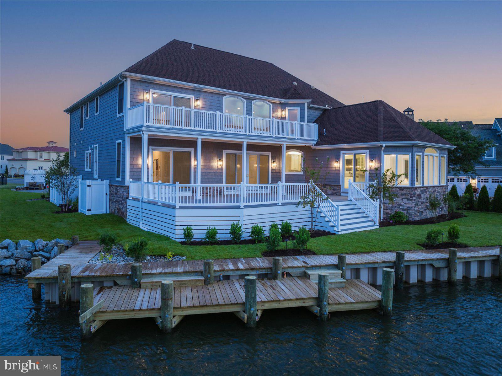 This is an Estate home, and the adjoining lot offered together for one price.   Luxurious Direct Waterfront Estate at Heron Harbour Isle, Ocean City, MD! Welcome to an exquisite waterfront retreat in Heron Harbour Isle, where luxury meets the serene beauty of coastal living. This stunning single-family home offers a rare combination of elegance, functionality, and breathtaking bay and canal views that will captivate you from the moment you arrive. With over 5400 sq ft of impeccably designed living space, this property is a true gem. The home, set on over 200 feet of prime water frontage, includes a 40 ft pier, two 10,000 lb boat lifts, and an additional pier with a convenient drop-down for kayaks and paddleboards. The new vinyl bulkhead ensures durability and style, providing a perfect backdrop for your waterfront adventures. The residence is complemented by the adjacent lot, both meticulously landscaped and featuring a brand-new irrigation system, creating a seamless outdoor oasis. Multiple decks on both levels of this two-story masterpiece offer endless opportunities for outdoor entertaining and relaxation, all while soaking in the panoramic water views. Step inside, and you'll be greeted by a grand entrance showcasing the stunning bay views that define this property. The spacious family room provides an ideal setting for gatherings, and the enormous kitchen, complete with a generous eat-in breakfast area, is perfect for culinary enthusiasts. The first-floor master suite is a sanctuary of luxury, featuring walk-in closets, an expansive primary bath with a shower and soaking tub, and a fireplace that enhances both the bath and the bedroom. Glass sliders lead out to the waterfront, allowing you to enjoy serene views right from your bedroom. A floating staircase ascends to the second floor, where you'll find three additional bedrooms, each with its own private bath, and a versatile game room that promises endless fun and relaxation. This remarkable home, with its unparalleled waterfront access, lavish interior features, and outdoor splendor, offers a unique and rare opportunity to experience the best of coastal living in Ocean City. Don’t miss your chance to own this unparalleled retreat. Imagine yourself in this beautiful home in one of the nicest communities in Ocean City. Heron Harbour Isle is amenity rich with two outdoor pools, an indoor pool, a kiddie pool, fitness center, social room, sauna, locker room, two Har-Tru tennis courts, sidewalks and piers. Enjoy your boat, fishing, crabbing, kayaking and paddle boarding all directly out your back door. Enjoy beautiful sunsets night after night. Short term owner financing available.  HVAC were installed in fall of 2016 3 ton & 5-ton, new roof7/20/2015, new siding 2015, exterior painting 2023, interior painting 2024, new decks 2024, additional interior and exterior remodeling 2023-2024.