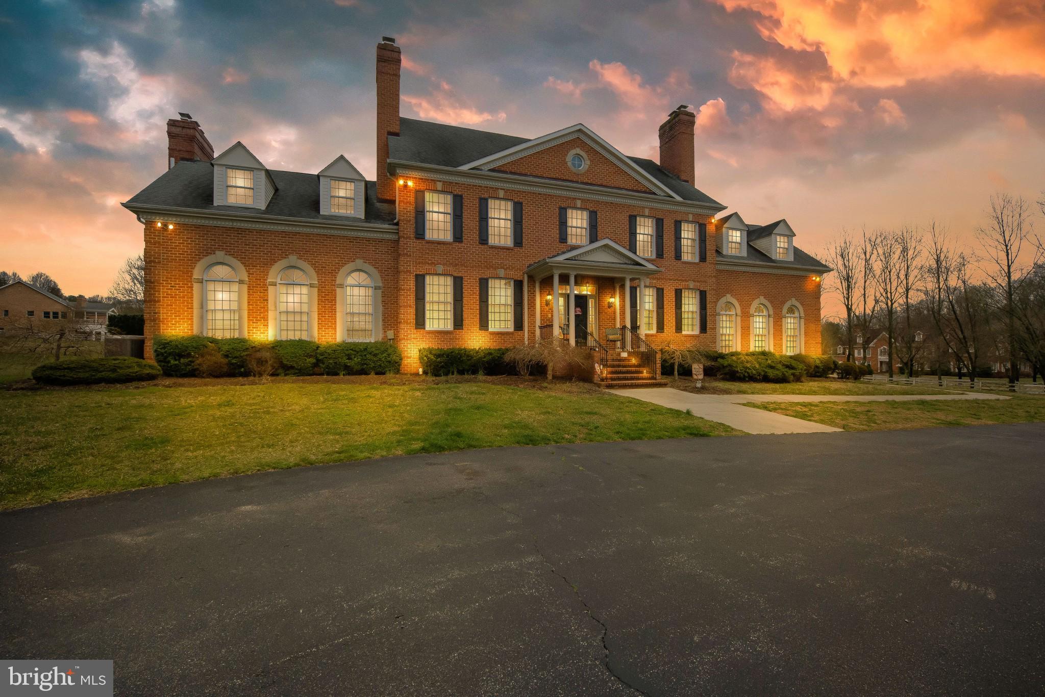 This beautiful estate home sits on over 10 acres and boasts over 7,000 square feet of living space and its own baseball field!  Entering this home through the front door you will step into the grand entry foyer with beautiful marble flooring.  To your left is a formal living room, and to your right is a formal dining room, both with hardwood flooring, double crown & chair rail moldings and both include their own gas fireplace!  Moving down the hall you will find the gourmet kitchen ahead.  The kitchen boasts Granite countertops, ceramic tile flooring, plenty of wood cabinet space, an oversized center island with a gas cooktop & ice maker, as well as a breakfast bar!  There is also a built-in desk, dual wall ovens and a SubZero refrigerator!  Adjacent to the kitchen is the large breakfast or dining area with access to the rear patio.  Stepping down into the family room you will find a brick wall fireplace, dual ceiling fans, recessed lighting, crown molding and great hardwood floors!  Through the double French doors you will enter the sunroom, which can also be used for a private office as well!   Making your way back through the kitchen and down the hall, you will see the convenient powder room, a laundry room with built-in storage shelves & a front-loading washer/dryer set, as well as access to the garage.  Making your way upstairs and around to your left you will find the expansive primary bedroom suite!  This bedroom includes a double-sided gas fireplace, wall-to-wall carpet and a ceiling fan.  You will also find the separate dressing area with a built-in vanity, a walk-in closet, a bonus sitting room or den, as well as the lavish private bathroom!  Down the hall are three additional bedrooms, including the spacious 2nd bedroom at the end of the hall with dual skylights and its own private bathroom!  The finished basement of this home offers an enormous recreation room, a private theater/media room, another full bathroom, a gym/exercise room and more!  The exterior of this home also features an in-ground swimming pool w/hot tub, a separate “pool house” with bathroom area, and a 6,000 sq. ft. Butler Clear Span Building that has multiple uses, such as a sports fitness barn, or a barn for equestrian uses, livestock or farming!  This home is just a short drive to NSA, Fort Meade and the Odenton MARC Station.  It is also located near all major roadways, plus plenty of shopping, restaurants & entertainment!