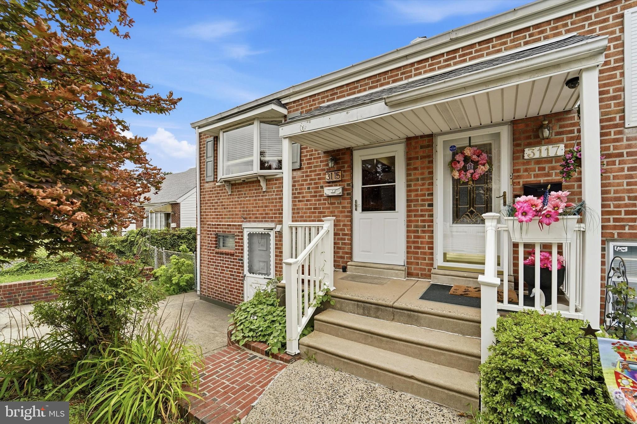 Welcome to this brick end-unit townhome situated on an oversized lot.  This 2 bedroom, 1.5 bath home has a finished walk-out basement with a 3rd bonus bedroom, so this layout gives your family plenty of space and a nice private layout.  You're greeted by a large 4-car driveway, with great curb appeal from the brick retaining wall and charming front porch. Step inside to find an open floor plan with attractive dark stained hardwood floors.  Great sight lines from the kitchen to the dining room & living room so the chef is never left out of the family fun.  A passthrough window from the kitchen to the living room is great for entertaining and gives the opportunity to create a breakfast bar with extra seating.  The L-shaped kitchen features maple cabinetry, stainless steel appliances (French door refrigerator, built-in microwave, and dishwasher), gas cooking range, and plenty of counter space.  On this main level you will also find 2 bedrooms with ample closet storage, and a full bathroom.  The finished lower level features a 3rd bonus bedroom plus a half bath, perfect for an in-law suite or multi-generational living. There is also a living room with large sliding glass doors that lead to the covered patio and impressive fully-fenced backyard.  There is so much you can do with this extra large backyard - host a family BBQ, enjoy a firepit on a crisp Fall evening, practice sports, start a hobby garden etc, all with the privacy you've been looking for.  Roof was installed in 2018 and the Hot Water Heater in 2024.  This home is being sold as-is and is waiting for its new owner to put the right finishing touches that will make it perfect.  Schedule your private tour today!