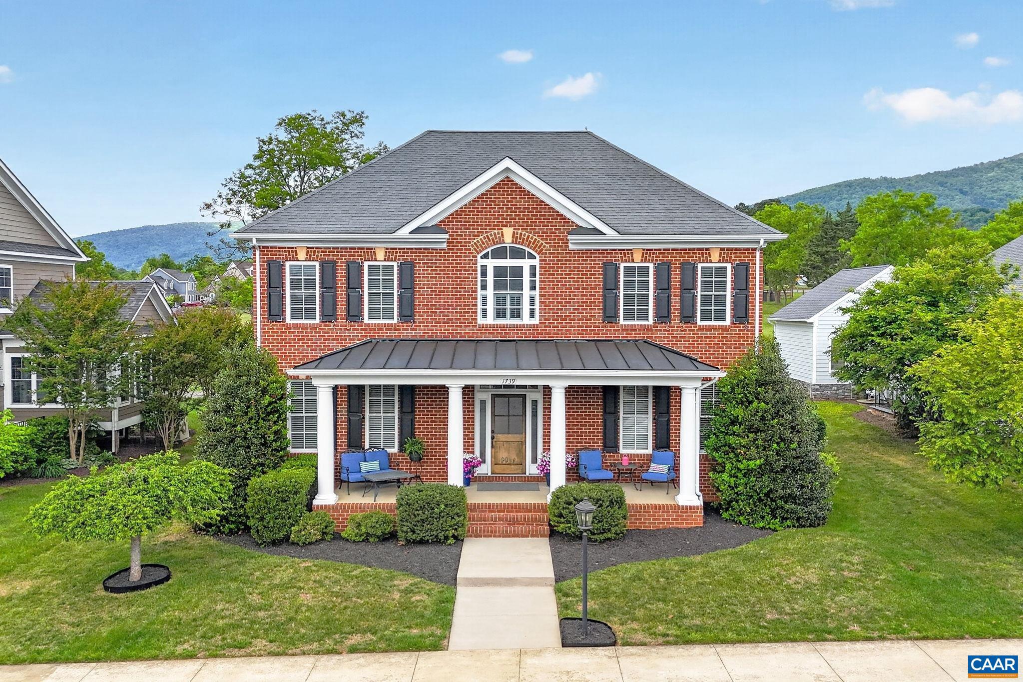 Stately and well maintained Old Trail home with unobstructed pastoral and Blue Ridge Mountain views! This builder's-own 5 bedroom, 4.5 bath home features 9' ceilings, hickory hardwood floors, 2 family rooms, mudroom with built-ins and closet, home office, in-ceiling Sonos sound, screened porch, patio with firepit, rear alley and so much more! White and bright chef's kitchen with commercial gas range/vent, wall oven/microwave, quartz counters, tile backsplash and eating island opens to the large family room with coffered ceiling and indoor/outdoor gas fireplace. The perfect spot for family togetherness and entertaining! Large primary bedroom with walk-in closet, tiled primary bath with dual sink vanity and large shower. Additional second level ensuite bedroom with bonus room. Basement level is walk out/up with windows, family room, additional ensuite bedroom, adorable below-stair play area and lots of storage. The welcoming front porch, rear screen porch with fireplace and patio with gas starting wood firepit are wonderfully relaxing outdoor spaces. The oversized garage rear faces the back alley and built in basketball hoop. Nicely landscaped yard and convenient Old Trail/Crozet location make this a wonderful Old Trail offering!,Quartz Counter,White Cabinets,Wood Cabinets,Exterior Fireplace,Fireplace in Family Room