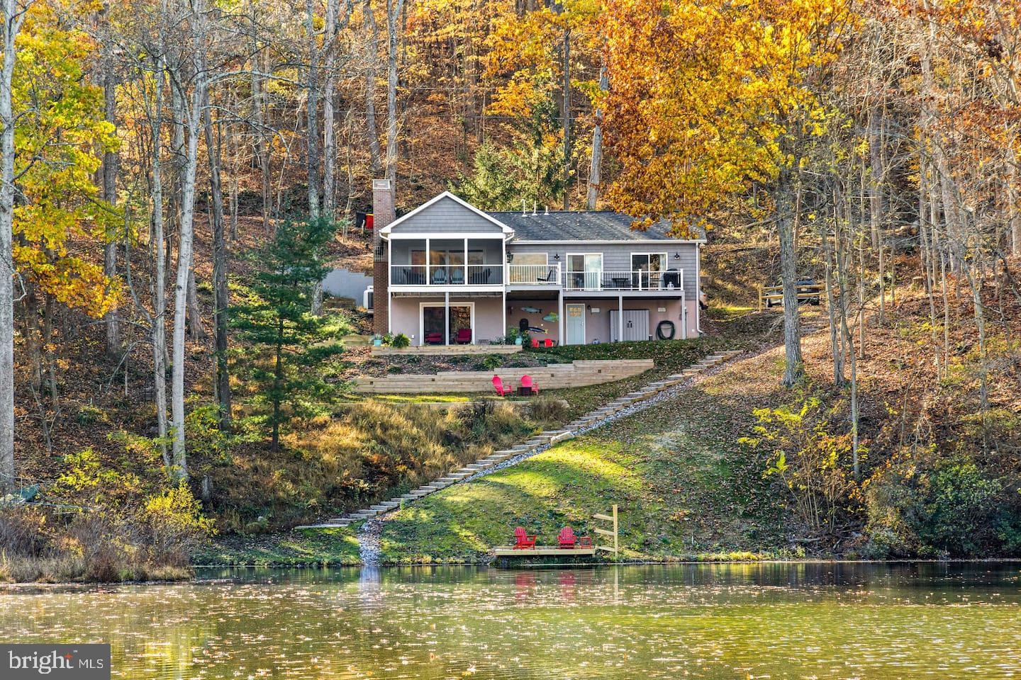 **Your private lake retreat, an hour from DC — with a turn-key rental program that helps pay the bills while you're away.**
 
If you've been looking for a weekend home on the water that doesn't demand a renovation project, finding a property manager, or your every free Saturday, this is it. Tucked at the end of a long, private cove on one of the DC area's most coveted lakes, this fully renovated two-bedroom retreat (plus a spacious basement den that can serve as a third sleeping space) is set up to be exactly two things: a place you'll love coming home to, and a property that earns its keep when you're not there.
 
*A VIEW YOU'LL WANT TO WAKE UP TO* 
Most lakefront homes here stare across a narrow channel at the neighbor's deck. This one looks up the cove — water in the foreground, woods on either side, Blue Ridge Mountains rising in the distance. It's the kind of view you'll find yourself describing to friends, then bringing them to see. Take it in from the great room, the deck, or the hot tub.
 
*PRIVACY THAT'S RARE ON THE WATER* 
The home sits at the far end of a cove — the most secluded address on the lake. A 700-acre state wildlife management area begins 100 yards from the door, with miles of trails for morning walks. When you want activity, the Mountain Lake Club is a short paddle away. When you want to disappear, you can.
 
*ALREADY RENOVATED — NOTHING TO DO* 
Taken to the studs in 2019 with tons of improvements: new electrical, plumbing, HVAC, septic, appliances, decks, landscape walls, and basement waterproofing. This work would run a year of your life to replicate. Skip the contractors. Show up on Friday with groceries.
 
*AN INCOME STREAM WITHOUT A SECOND JOB* 
The property has a solid four-year track record as a rental with a local full-service vacation rental program that handles bookings, guest communication, cleaning, and maintenance. Block off the weeks you want for yourself, list the rest, and let the rental income offset your carrying costs. No 2 a.m. guest calls, just easy income.
 
*THE HOME* 
Main floor — King primary suite with en suite bath
Main floor — Bedroom with two twin beds
Lower level — Private den suite currently outfitted with a queen bed
 
Waterfront, wood-burning stove fireplace, hot tub, private dock for kayaks and paddleboards, megabit WiFi available for the occasional work-from-the-lake week.
 
*CLOSE ENOUGH TO BE EASY* 
Dulles Airport: 50 min · Washington, DC: 1 hr 15 min · Baltimore: 1 hr 20 min · Harpers Ferry town & national park: 20 min · Loudoun wine country: 15 min · Appalachian Trail (Keys Gap): 10 min · Mountain Lake Club: 4 min
Close enough for a Friday-evening drive after work. Far enough that you actually feel away.
 
*THE BOTTOM LINE* 
Lakefront homes on this water rarely come up. One that's already gut-renovated, professionally rental-managed, and sited at the most private end of the cove with the finest view on the lake is a different animal entirely. This isn't an investment property pretending to be a getaway. It's a getaway that happens to pay for itself.