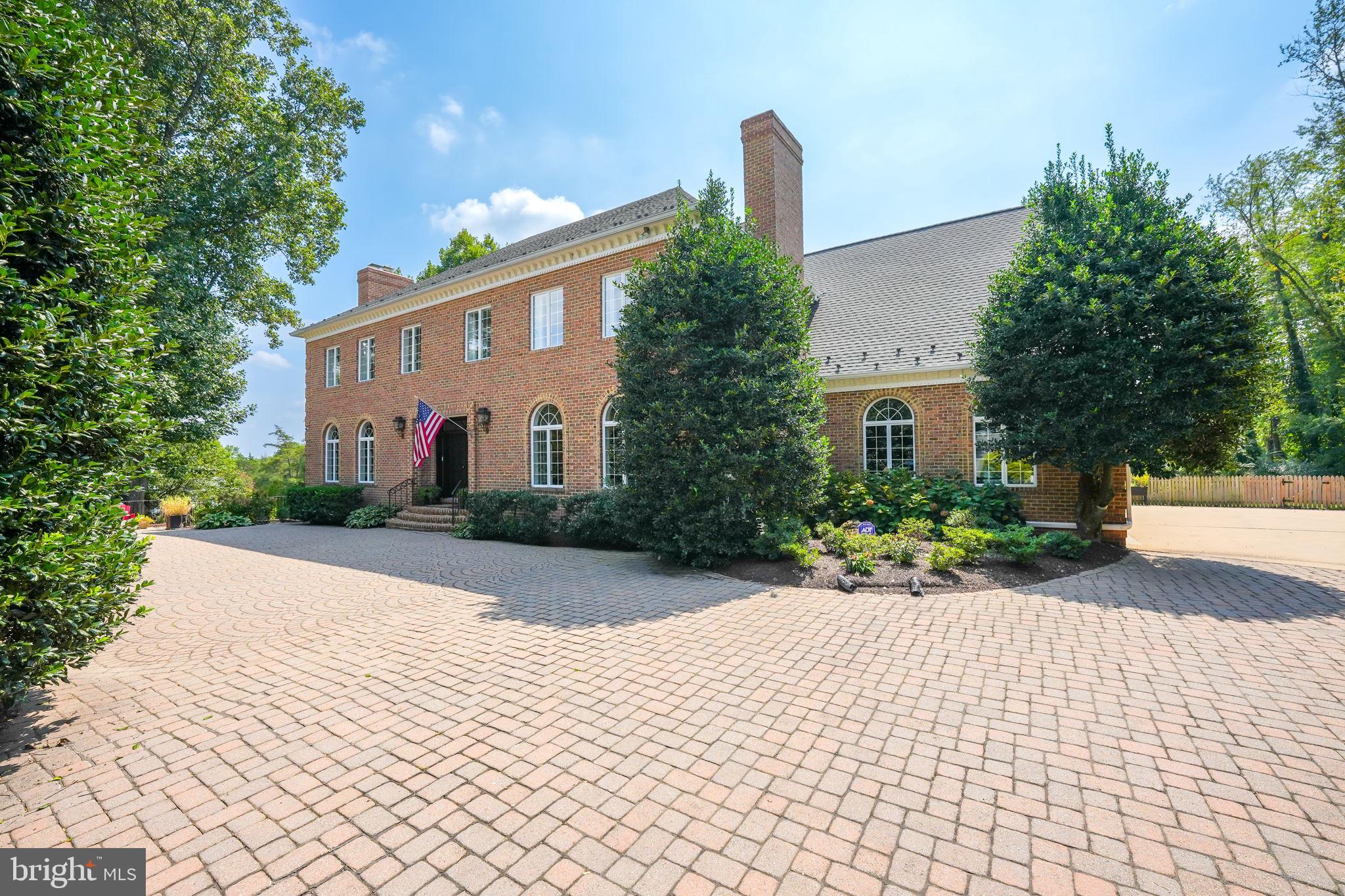 933 Bellview Road: The Essence of Refined Living in McLean

Poised on nearly an acre of lush, landscaped grounds in one of the most coveted addresses in McLean, Virginia, 933 Bellview Road is a striking 10,000+ square foot colonial estate that redefines luxury living. From its commanding curb appeal to its exquisitely curated interiors, this residence is a harmonious blend of timeless elegance and modern sophistication—designed for those who expect nothing less than the extraordinary.

McLean is a name that carries quiet prestige. Nestled along the Potomac River, just minutes from the nation’s capital, it is the preferred enclave for Washington’s elite. Known for its tree-lined avenues, proximity to premier private and public schools—including the highly regarded Langley High School—and seamless access to Tysons Corner’s world-class shopping and dining, McLean is a sanctuary of elegance and ease. Here, the comforts of nature meet the convenience of city living, all within a secure and serene setting.

An Entrance Made to Impress

As you step into the grand two-story foyer, you are met with an unforgettable sense of arrival. A sweeping dual staircase spirals gracefully beneath a custom chandelier that casts a warm, opulent glow across gleaming marble floors. The formal living and dining rooms mirror one another in sophistication—each anchored by stately fireplaces, soaring ceilings, and curated lighting that elevates every gathering to an occasion.

A Kitchen Designed to Perform

The heart of the home is a showstopping gourmet kitchen that seamlessly blends style and function. Anchored by an expansive island, this culinary space is outfitted with premium appliances, including a 5-burner Viking cooktop with downdraft ventilation, Dacor double wall ovens and warming drawer, Sub-Zero refrigerator, dual Bosch and Fisher & Paykel dishwashers, a wine cooler, and under-counter microwave. A sunlit breakfast area opens directly to the rear deck and grounds, allowing for effortless entertaining indoors and out.

Adjoining the kitchen, the family room is a warm, welcoming haven complete with a fireplace and wet bar, ideal for relaxed evenings or lively weekend gatherings. A spacious home office—tucked quietly at the rear of the house—features its own full bath and stall shower, making it a flexible space for guests or work-from-home serenity.

Elegant Living, Elevated

On the lower level, the home’s appeal continues with a full kitchen suite, private bedroom, state-of-the-art gym, wine cellar, two luxe bathrooms, and an expansive recreation space ideal for entertaining. Designer-selected flooring and custom finishes blend comfort with sophistication. French doors lead to a recently enhanced paver patio and a professionally landscaped rear yard, complete with refined lighting, lush plantings, and artful privacy design.

A Private Retreat Above It All

Upstairs, the private quarters offer sanctuary in every sense. The primary suite, fully renovated in 2021, evokes a spa-like ambiance with a soaking tub, dual vanities, and an oversized, glass-enclosed tile shower. Secondary bedrooms each boast en-suite baths and walk-in closets, ensuring every guest or family member enjoys their own private haven. At the very top, a large entertainment room awaits—complete with a wet bar, stainless steel wine chiller, ice maker, mini fridge, and generous storage—an ideal retreat for movie nights, celebrations, or moments of relaxation.

Thoughtfully Designed for Living Well

A discreet side-entry three-car garage connects directly to the kitchen, and both front and rear staircases ensure seamless flow throughout the home. Every inch of 933 Bellview Road has been carefully designed and meticulously maintained, offering refined living in one of Virginia’s most prestigious communities.

This is not just a residence—it is a statement. A celebration of space, privacy, and luxury.
Welcome to life at its finest. Welcome to 933 Bellview R