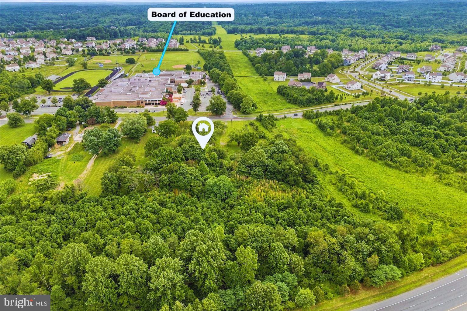 Rare 4.4-Acre Parcel Near Lake Needwood — Single-Family or Commercial Potential'

A rare land opportunity in one of Montgomery County's most desirable natural settings. This 4.4-acre property sits just steps from Lake Needwood and Rock Creek Regional Park, surrounded by walking trails, quiet woods, and a level of privacy that's increasingly hard to find this close to the city. An existing structure on the site holds no residual value and should be considered a teardown — the true value here is the land itself.

Zoned RE2, the property is well suited for a new single-family home or, subject to Montgomery County approval, certain commercial or special-exception uses. This flexibility makes it a strong opportunity for buyers looking to build a custom residence or explore commercial development in a corridor where parcels of this size rarely come available.

The location is exceptional: directly across from Col. Zadok Magruder High School, moments from the ICC for easy access to I-270, I-95, DC, and Baltimore, and surrounded by established neighborhoods where nearby homes have traded well into the seven figures. Nearby amenities include Norbeck Country Club, Needwood Golf Course, Leisure World Shopping Center, medical offices, and multiple major hospitals.

Whether your plan is a new custom home or a commercial use, 5904 Muncaster Mill Rd offers space, setting, and a location that speaks for itself. Sold as land value — buyer to verify zoning, utilities, and permitted use with the County.