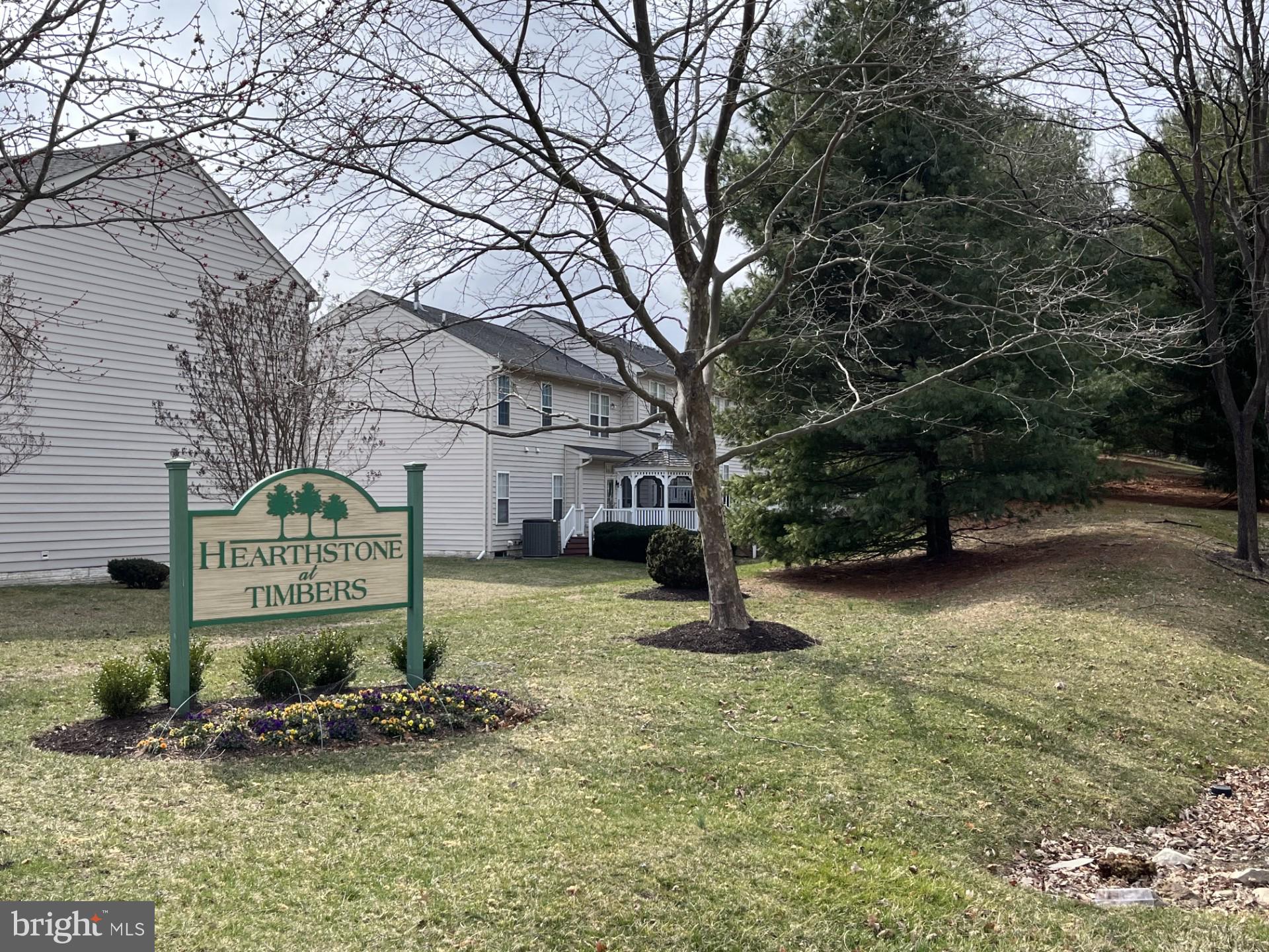 Back on the Market, through no fault of Seller.  Don't miss this incredible opportunity! This highly desirable floor plan is now available in Hearthstone at Timbers, a premier 55+ community in Elkridge, MD. Conveniently located near Rt. 95, it offers easy access to both Baltimore and Washington, D.C.

Step into this charming, sunlit second-floor unit, thoughtfully designed for comfort and convenience. The open-concept layout features a passthrough kitchen that seamlessly connects to the main living area. The kitchen is equipped with Corian countertops, an integrated sink, a pantry, and a laundry closet for ultimate functionality.

Enjoy your morning coffee on the private covered balcony, a perfect spot to relax. The condo is ideally configured with two spacious bedroom suites positioned on opposite ends for maximum privacy. The primary suite includes two closets, an en-suite bath with a walk-in shower, and a dual-sink vanity. The second bedroom suite features its own full bath with a tub/shower combo and linen closet—also accessible from the main living area for guest convenience.

Freshly updated with brand-new carpet throughout, this move-in-ready home also includes a dedicated office with elegant French doors and hardwood floors in the foyer. The building offers a secure lobby entrance with elevator access.

Don’t let this one slip away—schedule your tour today!