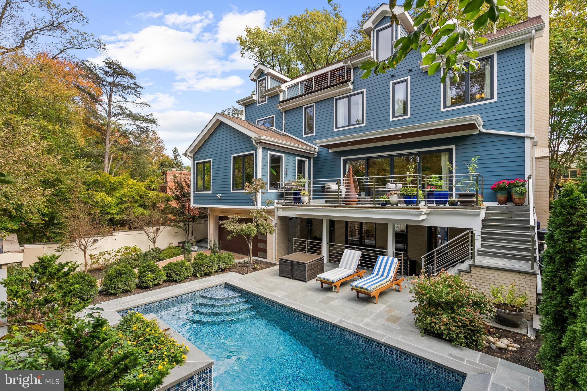 Completed in 2021, this custom built six-bedroom, five-and-a-half-bath residence exemplifies exceptional design and craftsmanship in one of D.C.’s most coveted neighborhoods. The home encompasses approximately 7,500 square feet on the inside and showcases an all-white brick exterior, triple-pane tilt-and-turn windows imported from Germany, and a masonry privacy wall that encloses the pool, hot tub and  grounds.

Inside, soaring ceilings ranging from 9 to 15 feet and Brazilian teak flooring create a striking sense of scale and sophistication. The main level features a cathedral-ceiling family room with a gas fireplace, an elegant living room,  dining area and family room - and all centered around a gourmet kitchen appointed with Brazilian quartzite countertops, custom cabinetry, and a separate scullery with its own outdoor access—perfect for entertaining. Walk out from the main level to the stone covered patio overlooking the garden and pool. 

The luxurious primary suite includes a tray ceiling, a private fireplace, generous walk-in closet, and spa-inspired bath with dual vanities, a soaking tub, and separate shower. Two additional bedrooms with ensuite baths and a full laundry room complete the upper level, while the third level offers two additional bedrooms, a vaulted-ceiling recreation room with wet bar, and a rooftop terrace ideal for entertaining or quiet retreat. 

The lower level provides exceptional flexibility with a large game room, exercise room, and full bath that conveniently serves pool guests. A two-car garage with interior access, utility room, and storage areas complete this level.

Luxury appointments include four fireplaces (three gas and one wood-burning), an elevator servicing all floors, a steam bath, and a heated saltwater pool with hot tub. Additional highlights include thermal flagstone terraces, stainless-steel railings, new water and sewer connections, and a tankless gas water heater. Zoned natural gas heating and electric cooling systems provide individual comfort control on each floor.

Set within the serene, tree-lined streets of Forest Hills, 5152 Linnean Terrace enjoys a rare balance of privacy and convenience. Just moments from the shops and restaurants of Connecticut Avenue, residents are steps from neighborhood favorites such as Politics and Prose Bookstore, Comet Ping Pong, and more. Nearby Forest Hills Playground, Soapstone Valley Trail, and Rock Creek Park offer endless opportunities for recreation and connection to nature—all while remaining less than fifteen minutes from downtown Washington.