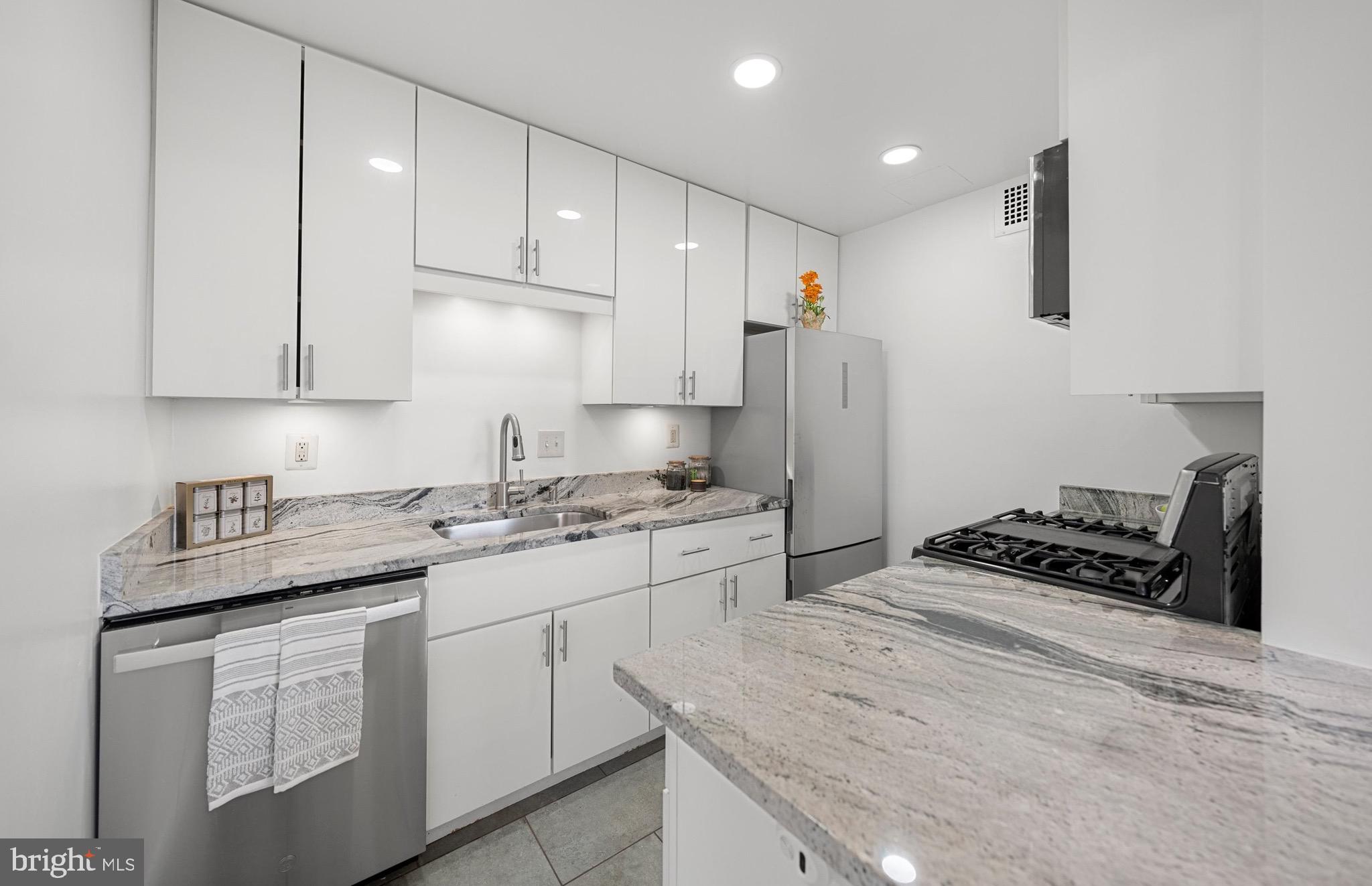 Welcome to Unit #804 at 4390 Lorcom Lane—a spacious, sun-drenched 2-bedroom, 1.5-bath condo with treetop and skyline views in a prime Arlington location. Perched on the top floor with higher ceilings and oversized windows, this light-filled residence offers the perfect blend of mid-century charm and modern updates.
Freshly painted and move-in ready, this home features recessed lighting and an open-concept layout. The updated kitchen boasts granite countertops, gas cooking, and upgraded appliances, flowing seamlessly into a bright dining area and expansive living space (approx. 22x12)—perfect for relaxing or entertaining. The spacious primary bedroom includes a 6x6 walk-in closet, while the second bedroom is ideal for guests or a home office.
Step back in time with style—this condo showcases two beautifully preserved mid-century bathrooms. The main full bath offers a bold vintage blue suite with coordinating tile, fixtures, and mosaic-style flooring. The half bath charms with its all-pink color palette, from tile and sink to toilet. Buyers will love the character and nostalgia, or they may choose to update and personalize these spaces to their taste.

Carlyn Place is a secure, professionally managed building with FOB access, elevator service, and an elegant lobby. The newly renovated community room on the top floor offers sweeping views and a full kitchen—perfect for hosting events. The building recently received a completely new roof, and a brand-new rooftop common area is scheduled for completion in the coming months. Residents also have access to a fitness center in the neighboring building, which is scheduled for complete renovation this summer. Each floor includes a smaller laundry room, and a larger shared laundry facility is located on the ground level, along with additional storage and a bike room—all included with the unit.

The monthly condo fee provides great value and covers nearly all living expenses: gas, electricity, water, sewer, two parking passes, storage, use of shared laundry, fitness room, and common spaces. There’s no need to maintain or replace your own HVAC system, water heater,  or laundry appliances—they’re all managed by the building. It’s truly low-maintenance, all-inclusive living.

Located in the desirable Waverly Hills neighborhood, adjacent to Cherrydale, both are known for their walkable charm, mature trees, and true neighborhood feel. Enjoy local favorites just around the corner, including Café Colline for French cuisine, Sloppy Mama’s Barbeque for wood-smoked classics, and Heidelberg Pastry Shoppe for fresh breads and pastries. Outdoor enthusiasts will appreciate the quick access to the Potomac Heritage Trail and Windy Run Park for scenic hikes, waterfall and outdoor exploration.

Commuting is easy with ART bus service right outside the building and quick 7-10-minute access to Ballston, Rosslyn, I-66, Route 29, and the GW Parkway. For those who prefer walking, Ballston Metro is just a 30-minute walk away, or grab a bike at Capital Bikeshare. Whether you drive, bike, or ride, getting around is a breeze.

Don’t miss this rare opportunity to own a top-floor condo with elevated style, timeless charm, and an unbeatable location in the heart of North Arlington!