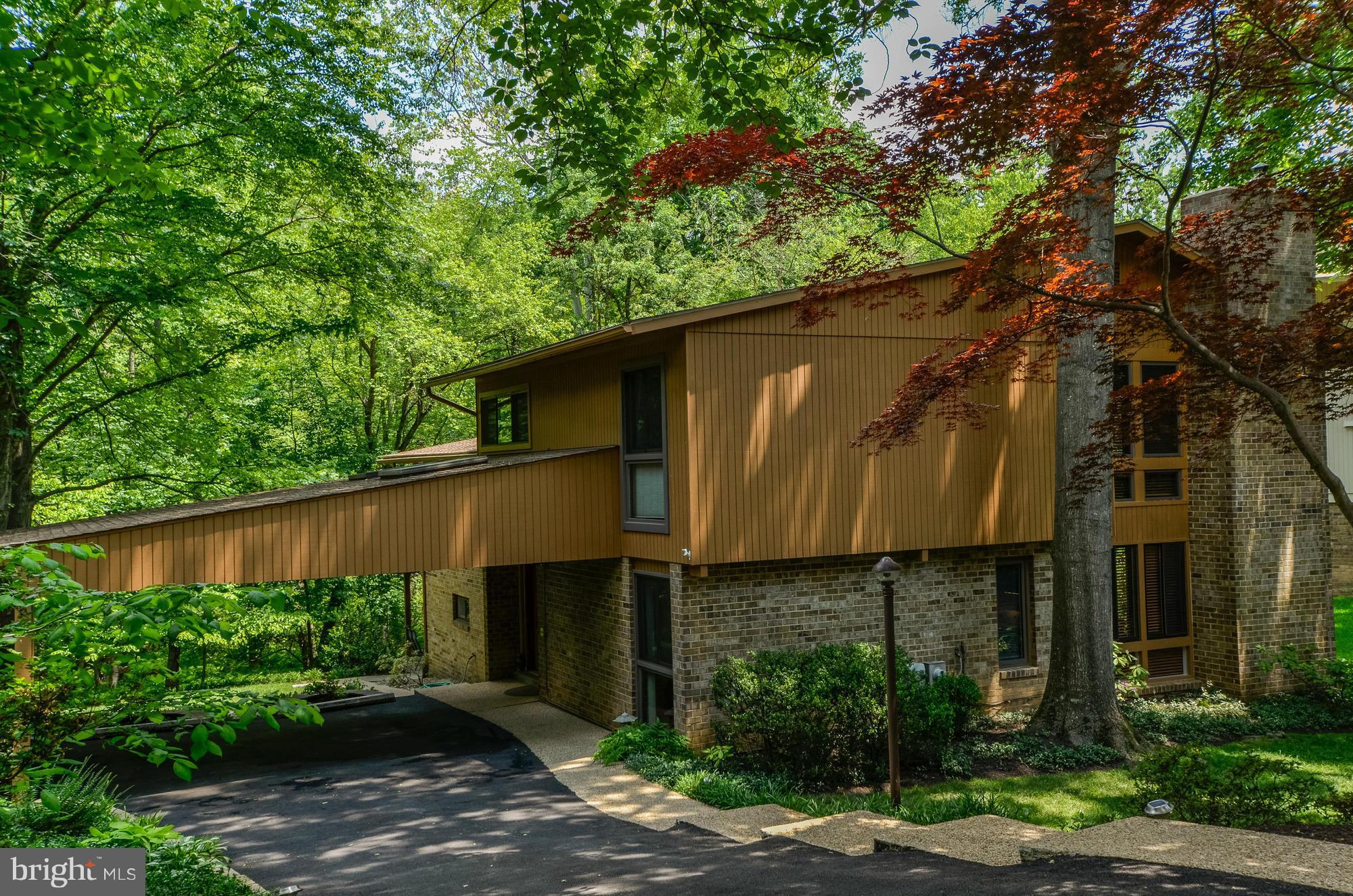 Lovely, light-filled Contemporary 4BR/3BA home overlooking parkland w/ beautiful nature views. Sleek and updated with fantastic living spaces + great outdoor space. Living/Dining Room features a wall of windows + vaulted ceilings. Updated Kitchen, Option for Main Level Bedroom. LL walkout to Patio. Spacious Trex Deck perfect for entertaining. 2-car carport with skylights.