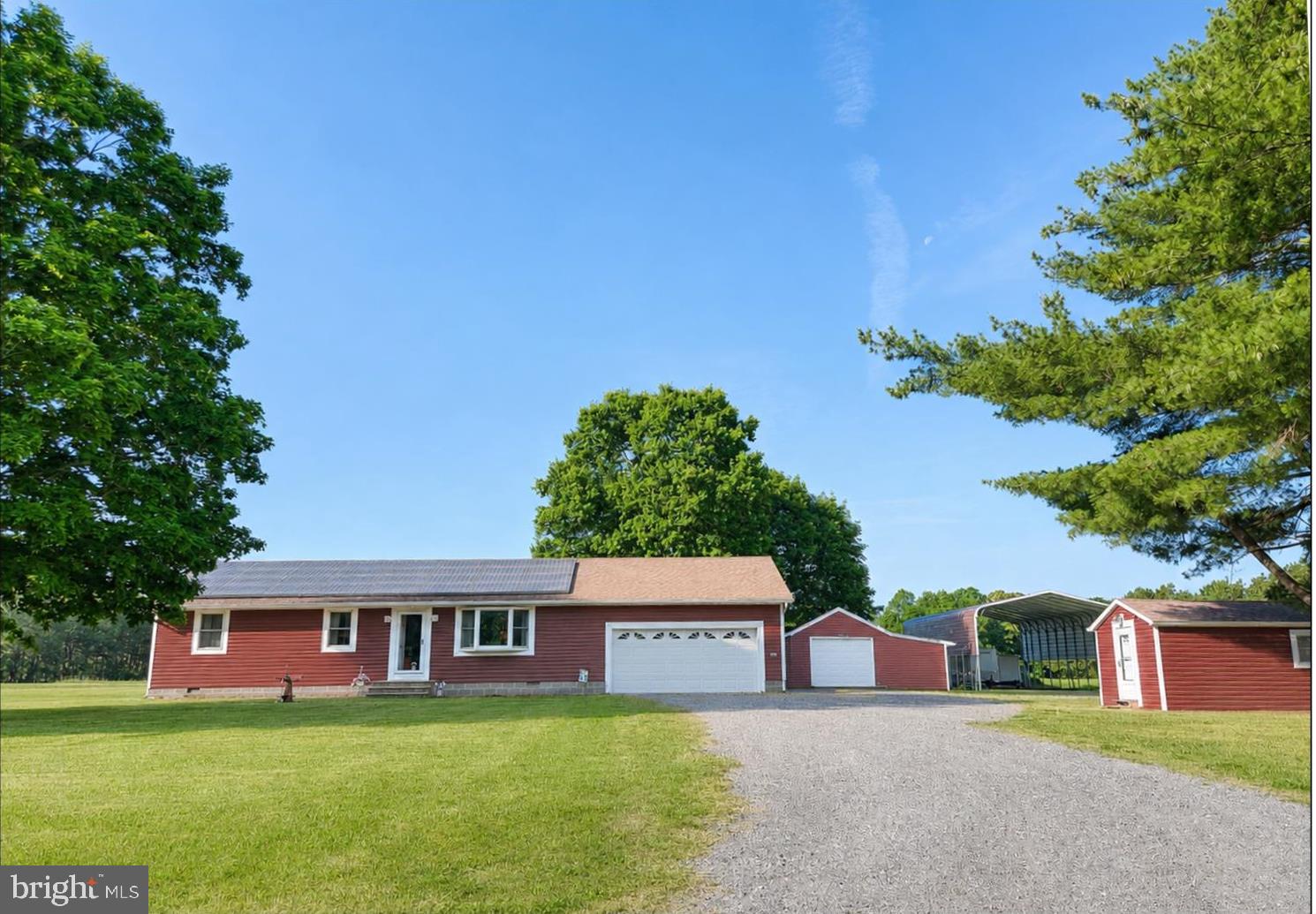 Enjoy the peace and privacy of country living on this lovely 4.68-acre property. This well-maintained one-level rancher features durable luxury vinyl plank (LVP) flooring and an upgraded kitchen with elegant quartz countertops, ample cabinetry.
This home offers 3 bedrooms and 2 full baths, providing comfortable living space for family and guests. Exterior features include low-maintenance vinyl siding and an attached 2-car garage.
For those needing extra space, this property delivers! There is a detached out building with a  1-car garage, a workshop and lean-to, while the RV carport, 24x48, provides covered storage for recreational vehicles, boats, or equipment.  Plus, there is a separate heated and cooled studio offering endless possibilities for a home office, art studio, fitness room, hobby space, or guest overflow.  No HOA.   Solar Panels lower electric bills.  A rare opportunity to own acreage with versatile outbuildings, modern updates, and room to spread out—all in a peaceful country setting.