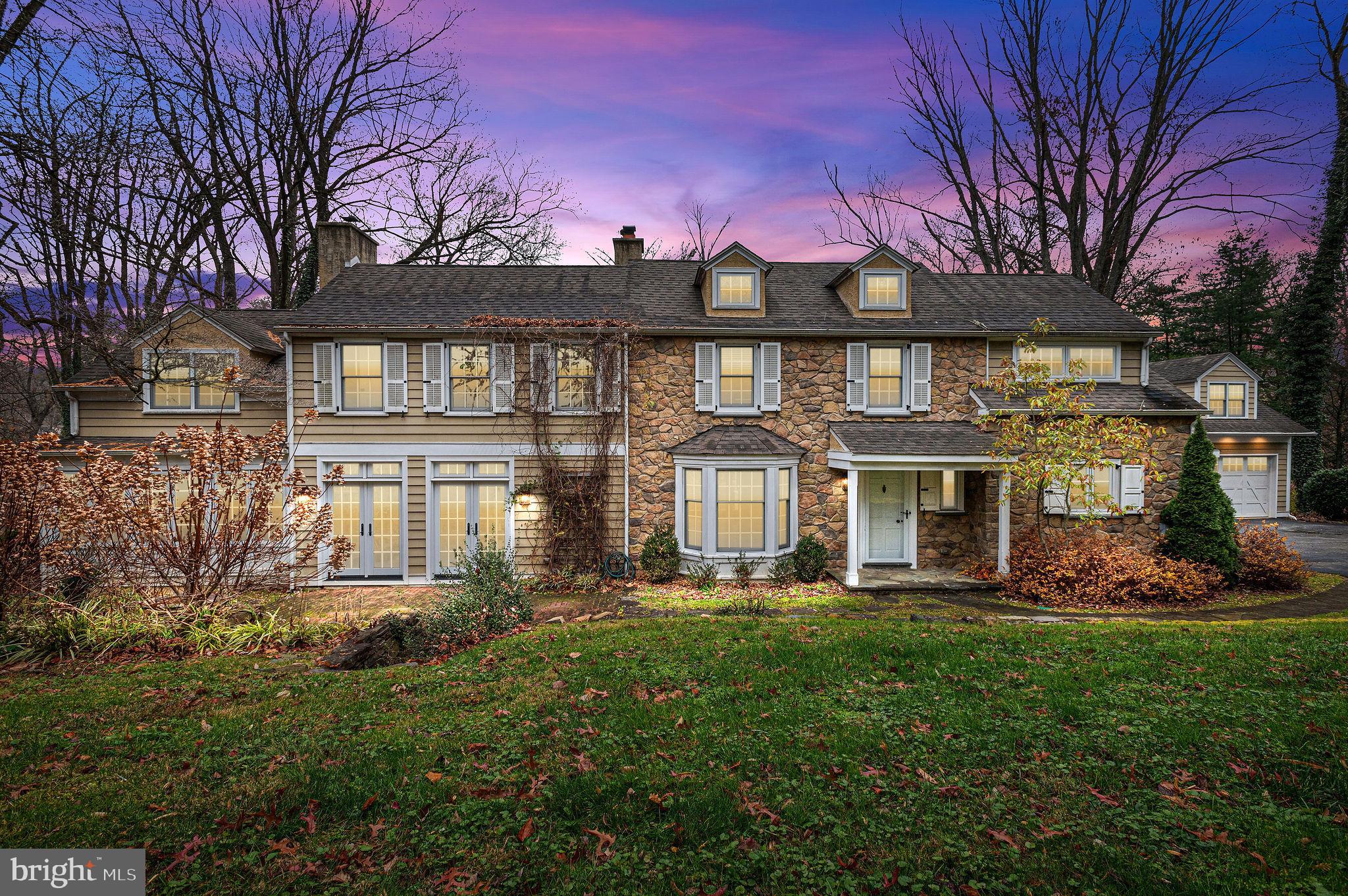 A must see, this stunning Main Line stone Colonial is the home of your dreams! Beautifully appointed, this home boasts a classic farmhouse style with modern amenities, an open floor plan while still maintaining historic charm.  Nestled on a private 2 acres, this home will meet your every need inside and out!  The landscaping has been meticulous maintained and even includes a picturesque creek running through the rear of the property.  As you enter this beautiful home, you will notice the gorgeous hardwood flooring that is carried throughout the house, along with wainscoting, crown molding, and recessed lighting that evidences the great attention to detail that has been given to every space.  The large entryway and mudroom branch off into an illuminated pantry and beautifully milled half bathroom.  Perfect for entertaining in size and layout, the sun-drenched, spacious gourmet kitchen is any cook's dream!  Custom cabinetry with subway tile and granite counter tops for days as well as an expensive center island and large breakfast area provide all the space you need for serving a crowd!  Or celebrate in the massive formal dining room with a beautifully detailed wood-burning fireplace and stunning double French doors.  Then retire to the large living room with a second wood-burning fireplace and sunny bow window.  The gorgeous hardwood floors and millwork continue to shine here as well.  The cozy family room includes full length window seating and tons of naturally light from windows on both sides of the room. An absolutely gorgeous, chandeliered staircase leads to the second floor with a bright open landing, 4 generous bedrooms, 3 full bathrooms, and an enclosed laundry area.  While the hardwood floors continue through the second floor, the bathrooms offer the ultimate comfort with radiant floor heating!  All bedrooms have illuminated closets that activate with the opening of the doors. The owner's suite has spacious his and hers walk-in closets with custom organizers, and a showcase ensuite bathroom with his and hers granite top sink vanities, makeup vanity, and large soaking tub in it's own naturally lit nook. French doors and wall sconce lighting complete the high end look of this stunning bathroom!  The remaining bedrooms continue the beautiful hardwood flooring, spacious closets, and generous natural light. Two hall baths have gorgeous tiling, and heated (radiant) flooring.  This home also includes a detached garage with a finished second floor - perfect for an office, studio, or just extra living space as it is heated and air conditioned! Lastly the main house has a large attic for tons of storage!  And it should be noted that this home has 4-zone heating powered by a high efficiency heating system.