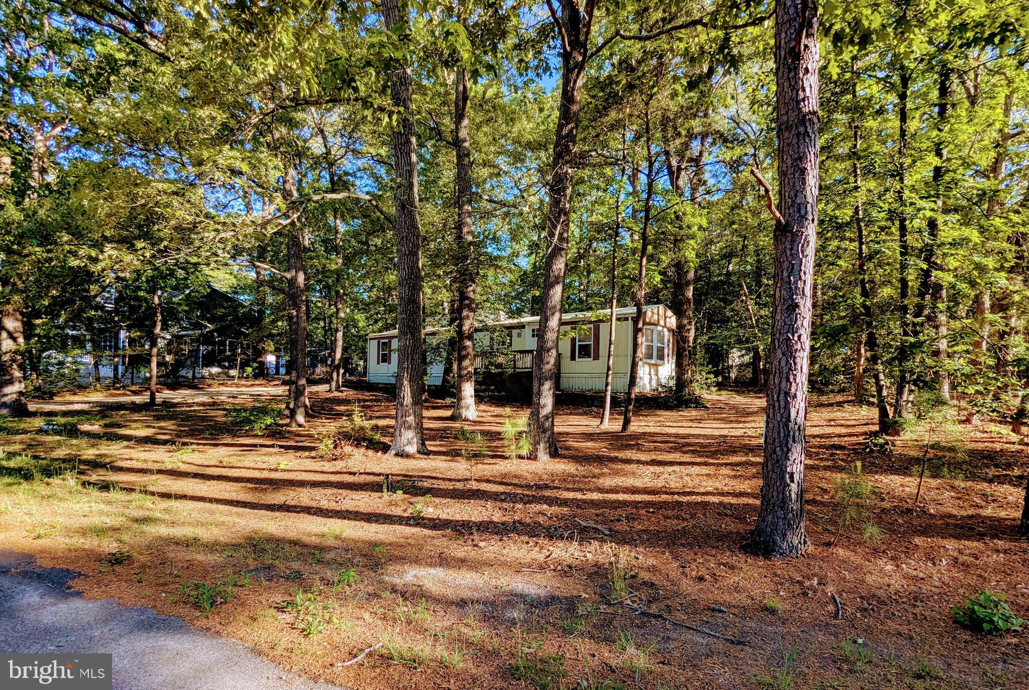 PRICE JUST REDUCED! Welcome to your charming new home, a delightful ranch-style manufactured residence built in 1986 and restored in 2013 with ongoing updates.  New Dishwasher, Frig & Stove and Roof got a new coat in 2024. this year. Offering a perfect blend of comfort and functionality. With 1079 square feet of thoughtfully designed living space, this inviting property features two cozy bedrooms and a well-appointed full bathroom, making it an ideal retreat for relaxation. Step inside to discover the warm ambiance created by recessed lighting and upgraded countertops that enhance the kitchen's appeal. The updated electric oven/range, along with the convenient washer and dryer, ensures that your daily routines are effortless and efficient. Outside, the property boasts a generous 0.3-acre lot, providing ample space for outdoor activities or gardening. Additional exterior features include outbuilding and bump-outs that add character and functionality to the property. This home is not just a place to live; it's a sanctuary where
 you can create lasting memories. Enjoy the tranquility of your surroundings while being just a short drive away from local amenities. Whether you're entertaining guests or enjoying a quiet evening at home, this property offers the perfect backdrop for your lifestyle. Don’t miss the opportunity to make this lovely residence your own! Builders Keep This in Mind for Clients.  Located East of Coastal Highway and conveniently located to the Bike Trail with new sidewalks on Munchy Branch Road & all the resort activities. The values in this resort community continue to increase with custom construction replacing dated homes.