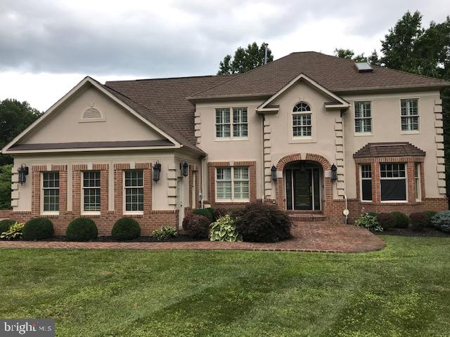 WELCOME HOME!!Beautiful custom home in custom home community.  Property is gated and privately fenced  with three car garage.  First floor has  sun room,  two story  family room with second set of stairs to upper level,  spacious formal living and dining rooms, home office, beautiful kitchen  stainless steel appliances, granite counter and backsplash, breakfast room and power room. Enter huge deck from both sun room and breakfast room.   Custom shutters throughout home.  Hardwood floors on main and lower levels. Lower level is entertainers dream!! Has theater room  with multi level seating,  large screen with projector, granite topped bar with sink, wine refrigerator, storage.  Recreation room has a pool table, wet bar with  walk out to brick patio.  LL living room has fireplace and large powder room.  Follow to the upper bedroom level.  There are two bedrooms with adjoining Jack and Jill bathroom.  Another guest  bedroom has private bathroom.  Beautiful owners suite with a morning room for your coffee, skylight, marble bathroom with separate shower and tub.  This is a home you will love to LIVE IN.  WELCOME HOME!!