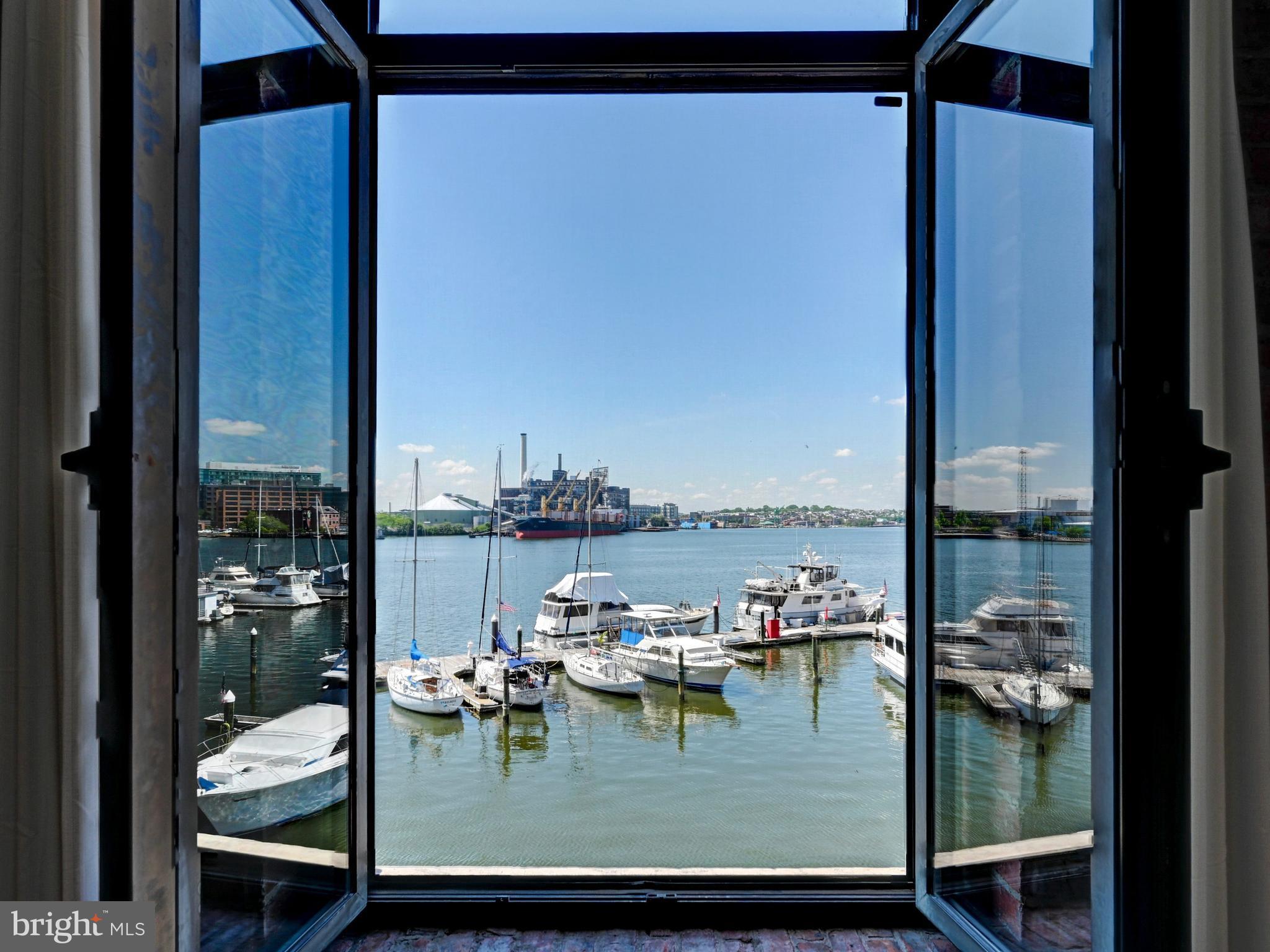 Fantastic two-bedroom, two-bath loft condo with direct water views in historic Fells Point. This fully renovated two-story residence offers a spacious and versatile layout, with one bedroom on the main level and another on the upper level.
The updated kitchen features granite countertops and top-of-the-line appliances, opening to a bright living space with hardwood floors throughout the main level. The large primary suite includes a walk-in closet and a spa-like bath with both a separate shower and  tub.
Ideally situated in one of the best locations in Fells Point, enjoy easy access to the neighborhood’s vibrant restaurants, shops, and waterfront just steps from your door.