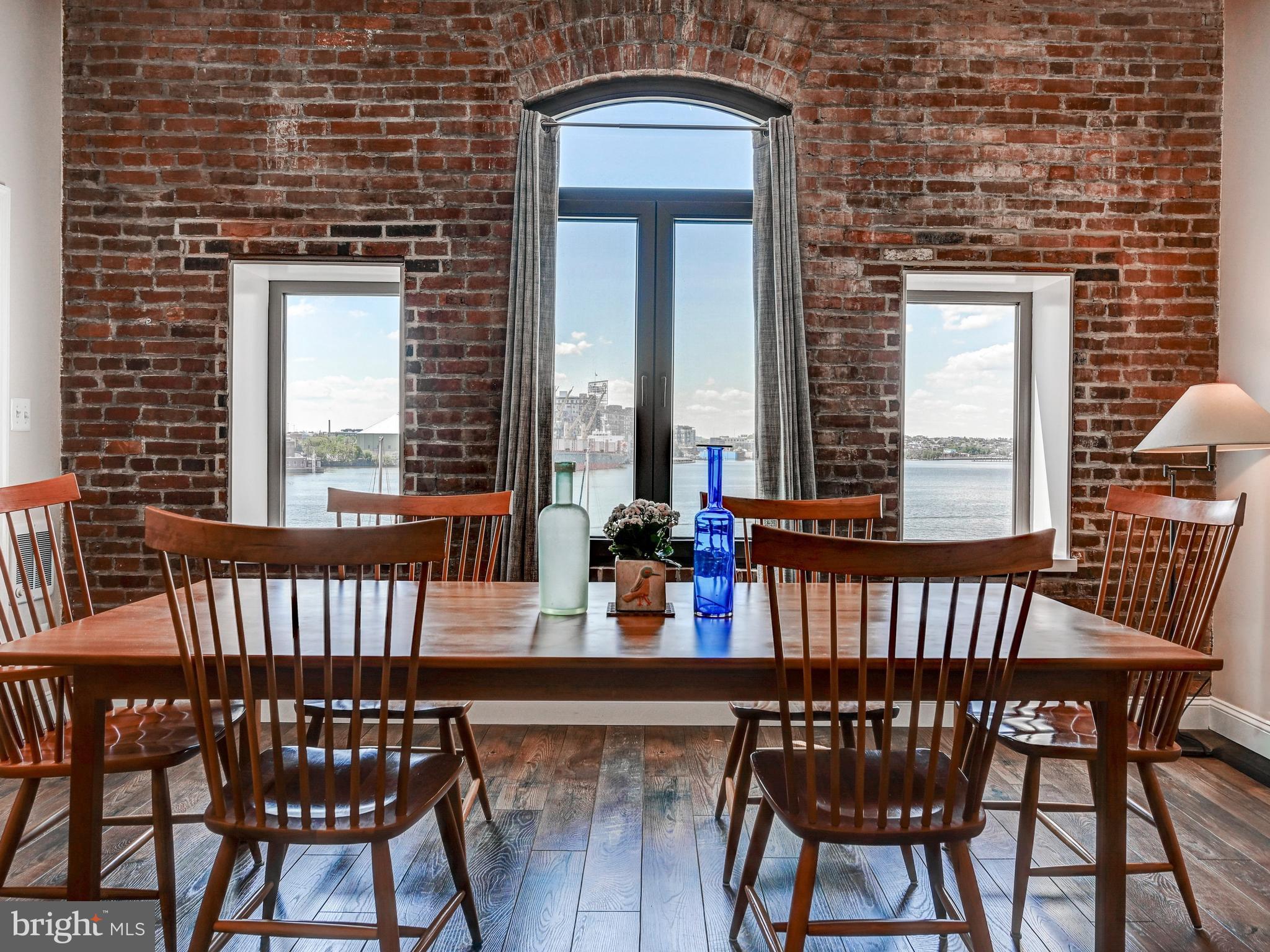 Fantastic two-bedroom, two-bath loft condo with direct water views in historic Fells Point. This fully renovated two-story residence offers a spacious and versatile layout, with one bedroom on the main level and another on the upper level.
The updated kitchen features granite countertops and top-of-the-line appliances, opening to a bright living space with hardwood floors throughout the main level. The large primary suite includes a walk-in closet and a spa-like bath with both a separate shower and  tub.
Ideally situated in one of the best locations in Fells Point, enjoy easy access to the neighborhood’s vibrant restaurants, shops, and waterfront just steps from your door.