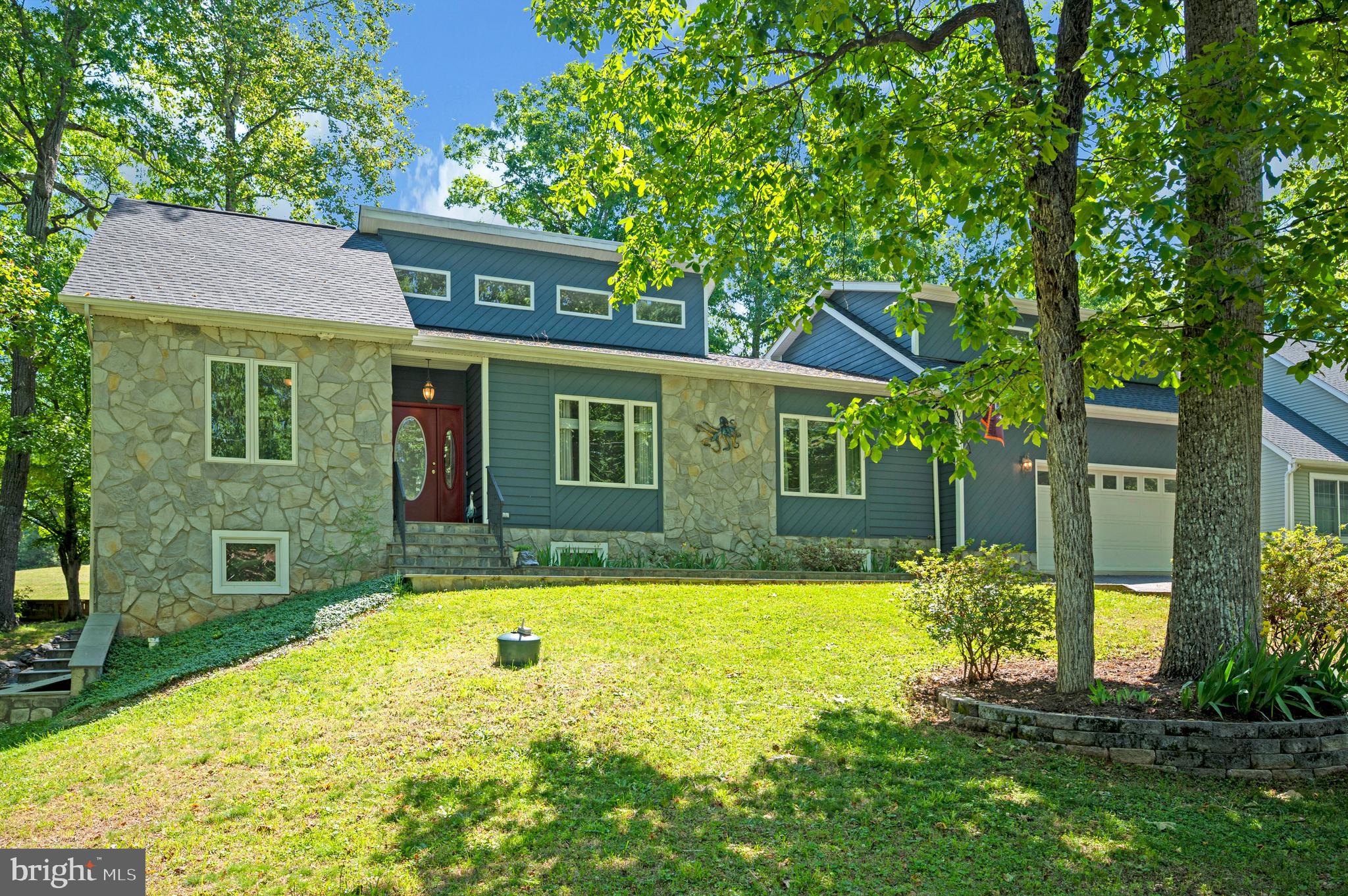 A premium Par 3 Golf Course lot that backs up to putting green,  a custom home built by a local master home builder, “Design Craft,” with wide-open views, the perfectly maintained greens, and the sense of space create an atmosphere that's difficult to replicate at 203 Limestone Lane. 

The home’s curb appeal sets the tone from the moment you arrive.  A beautifully designed slate stone walkway through manicured landscaping and a lush lawn before leading you inside. Your backyard steps off directly onto a pristine par-3 putting green, framed by a spectacular 180-degree panoramic view. Complete with an attached golf cart garage/shed conveniently located on one side and an elegant slate stone patio in the back that wraps around the other side of the home with slate stone steps leading seamlessly to a fully finished basement entry. 

The living room immediately commands attention with soaring 20-foot-plus ceilings with natural light gleaming through and an impressive stone wall fireplace that anchors the space while adding warmth and character. Whether you're entertaining friends or enjoying a quiet evening at home, this is a room designed to bring people together.

Just beyond, the kitchen balances functionality with connection. Recessed lighting, ceramic tile flooring, a breakfast bar, and a new dishwasher and stove make everyday living effortless, while the adjoining dining room is wrapped in natural light and framed by views of the golf course. It's the kind of setting that turns ordinary dinners into memorable moments.

Outside, the beautifully patterned slate stone patio feels like a natural extension of the home. Morning coffee tastes a little better with the fairways stretching before you. Evenings become a chance to unwind as the changing light settles across the greens. Without neighbors directly behind, the backyard offers a rare sense of openness that's as peaceful as it is beautiful.

The home's flexibility continues beyond the kitchen, where a pantry, laundry room with brand new washer and dryer, and access to the garage lead to the spacious bonus room above. Complete with brand new carpet, a ceiling fan, a half bath, and its own private balcony overlooking the course, this space offers endless possibilities while giving you yet another place to enjoy the view.

The primary suite provides a comfortable retreat featuring dual sinks, a soaking tub, and a separate walk-in shower. Two additional bedrooms complete the main level, while the finished basement expands the home's possibilities even further. With two additional bedrooms, a full bathroom, a generous recreation area, extra storage, and direct access to the side yard, there's room to accommodate guests, hobbies, or whatever life brings next.

While the home itself is exceptional, the setting makes it unforgettable. Whether you're an avid golfer or simply appreciate the beauty of living beside one of the community's most picturesque landscapes, this home offers a front-row seat to the scenery every single day.

Beyond your backyard lies everything that makes Lake of the Woods one of the region's most desirable gated communities. Residents enjoy access to two lakes, beaches, boating, kayaking, water skiing, an equestrian center, golf, fire and rescue services, a church, and more than 60 clubs and organizations. Every day brings another opportunity to explore, connect, or simply enjoy the lifestyle that has drawn so many to this community.

Located in Orange County, residents also benefit from low real estate taxes while enjoying a community where homes range from the $300,000s to more than $2 million. If you've been searching for a home where peaceful golf course views, flexible living spaces, and an exceptional community come together, 203 Limestone Lane is ready to show you what everyday living can feel like.