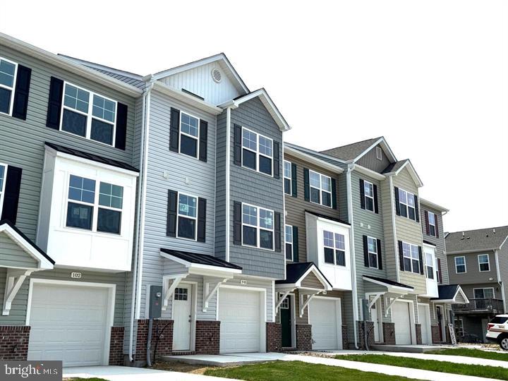 Under Construction....Brand New Townhomes in The Communities of Burwell!  Discover the perfect blend of comfort, style, and convenience in these beautiful new townhomes offering approx 1560sq. ft. of thoughtfully designed living space with Unfinished lower level for future expansion.  The open main level welcomes you with luxury vinyl plank flooring, a spacious family room extension, and a stunning kitchen featuring granite countertops, stainless steel appliances, and a large island with bar seating—ideal for entertaining or everyday living. Upstairs, the impressive primary suite showcases vaulted ceilings, a generous walk-in closet, and a spa-inspired bath with a tile shower and glass door. Two additional upstairs bedrooms provide plenty of space for family, guests, or a home office.  A brick-accented exterior, 1-car garage with opener, and concrete driveway complete the package—enhanced by ample overflow parking just steps away for added convenience.  Ideally situated just minutes from I-81, shopping, grocery stores, and popular restaurants, The Communities of Burwell offers both modern living and everyday ease.    Similar construction available to view.  Photos are of similar construction.