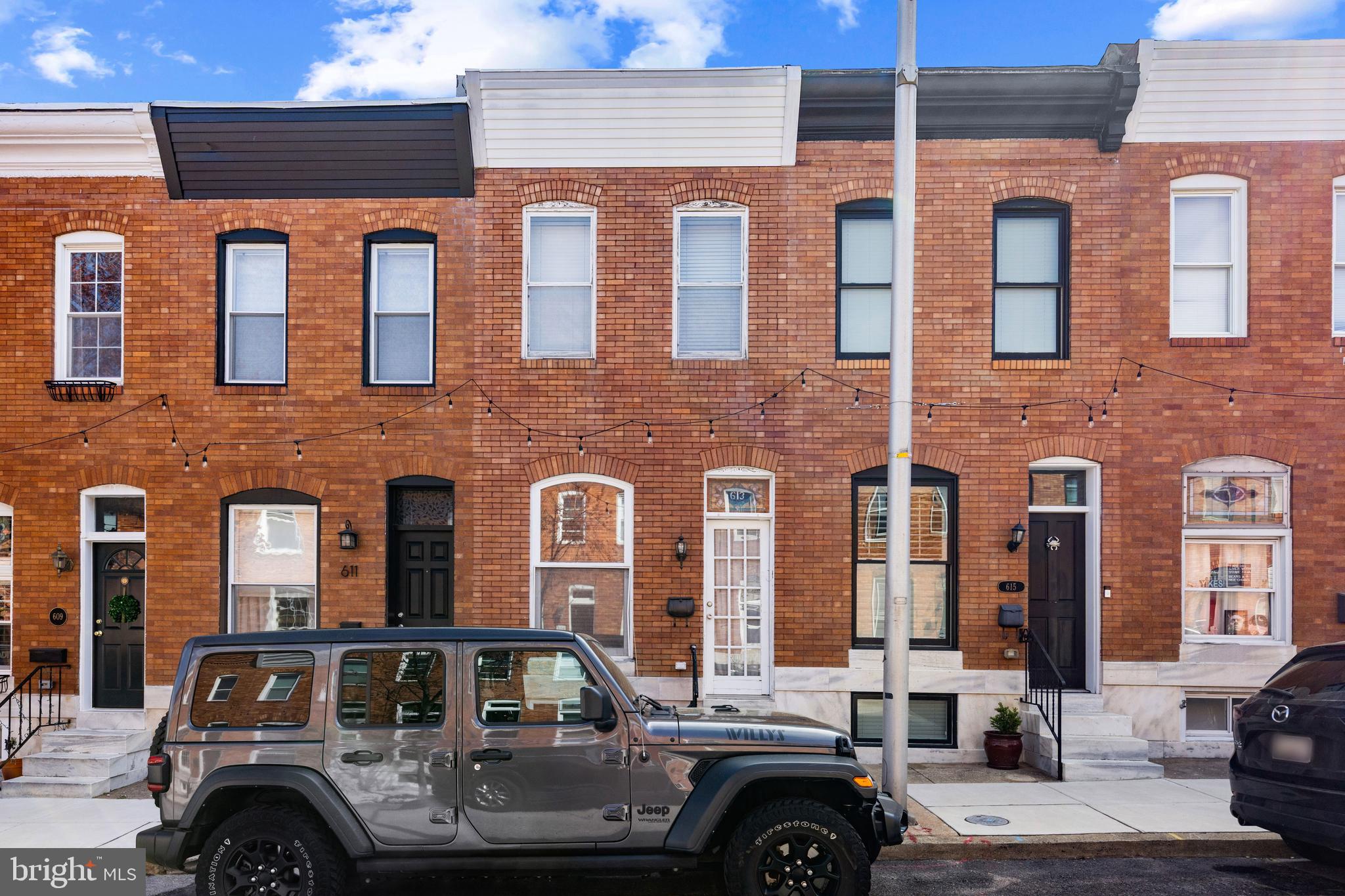 Welcome to the epitome of urban living in the heart of Canton. This exceptional 3-bedroom, 1.5-bath townhome with a private parking pad blends classic Baltimore charm with modern functionality. Step inside to discover warm hardwood floors, exposed brick, and thoughtful updates throughout. The main level features a comfortable and open living space, ideal for both relaxing and entertaining. Upstairs, you’ll find two generously sized bedrooms, including a sunlit primary bedroom, full bath, secondary bedroom and skylights. The finished lower level offers flexibility with a third bedroom or bonus room perfect for a guest suite, home office, or gym along with a convenient half bath, storage, and laundry area. Situated on one of Canton’s most desirable blocks, this home offers unbeatable walkability to Canton Square, Patterson Park, restaurants, and more. With easy access to major highways and commuter routes, this home delivers the best of city living with the comfort of a neighborhood feel. Don’t miss your chance to call this gem your own!