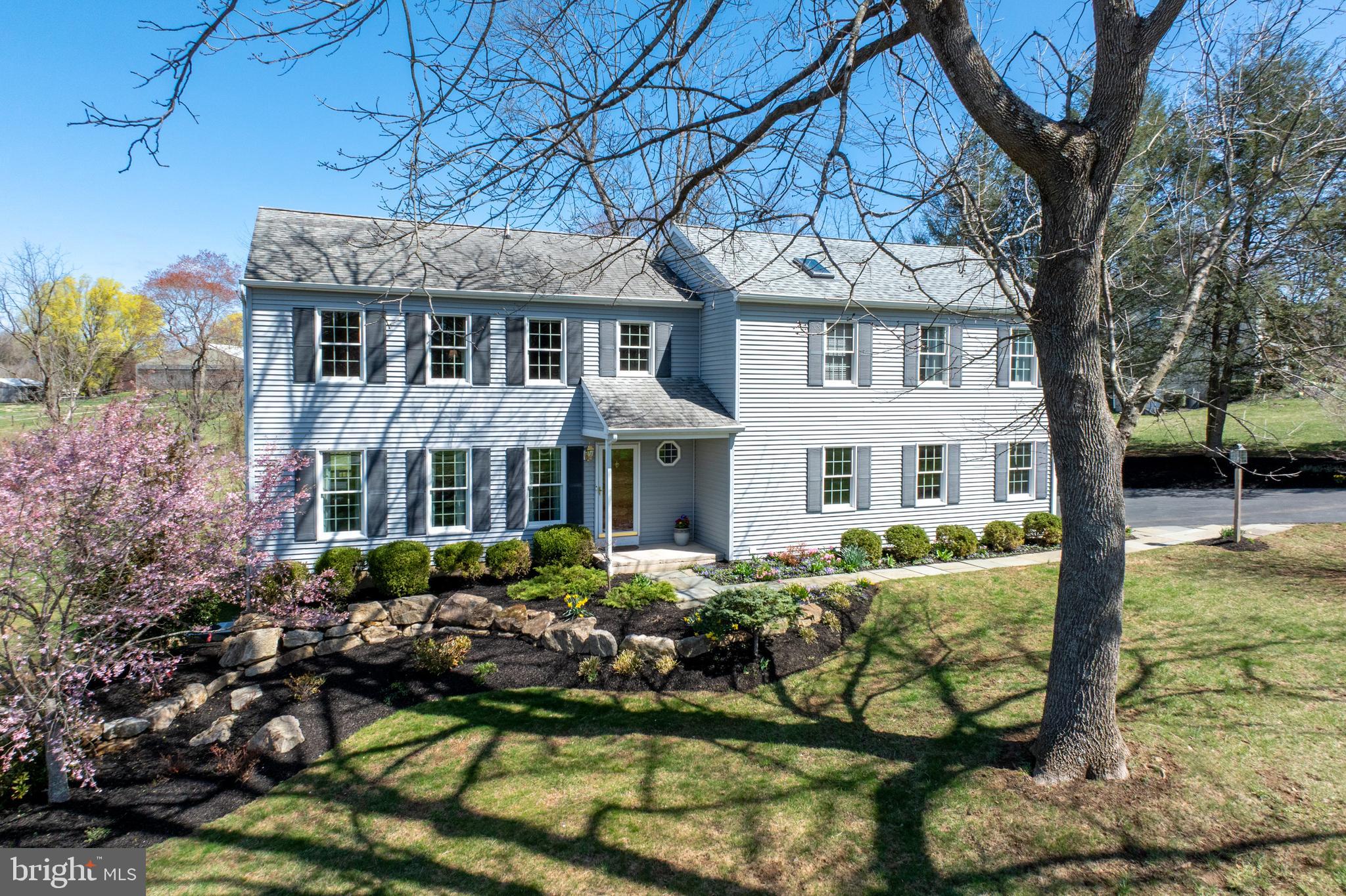 Nestled on a serene one-acre lot within the sought-after Downingtown East School District, this beautifully expanded 4-bedroom, 3.5-bathroom home has been meticulously maintained and thoughtfully updated by its original owner. A stunning family room addition serves as the heart of the home, featuring a floor-to-ceiling stone gas fireplace, rich hardwood floors, and an Andersen French door leading to a spacious TimberTech deck—perfect for relaxing or entertaining. The kitchen has been expertly remodeled by a reputable builder, showcasing Honey Brook Custom Cabinets, exquisite granite countertops, and high-end appliances, including a Wolf 5-burner gas cooktop, Bosch electric oven, microwave, and refrigerator, as well as a Miele dishwasher with a panel that blends seamlessly into the cabinetry. Additional features include a tiled backsplash, built-in wall cabinet with hidden outlets, an instant hot water faucet with a filter, and recessed lighting with multiple switches. Step through the Andersen French door with transom window to the deck, where you can enjoy your morning coffee at the built-in bar or host gatherings with friends and family. The main level also offers a formal living room, dining room, an updated powder room with a granite-topped vanity, and laundry room with a closet, cabinets, and access to the 2-car garage with an alcove for extra storage space and side door to a stone walkway. Upstairs, the impressive primary suite addition features a vaulted ceiling with a fan, walk-in closet, linen closet, and a spacious private bath with a jetted corner tub,  double-bowl vanity with a Tere-Stone top, and a tiled shower. Down the hall, two bedrooms share a hall bath with a tub, tiled floor and linen closet, while the fourth bedroom boasts a walk-in closet and an updated private en-suite bathroom. The unfinished basement provides excellent storage space and includes a convenient walkout door to the side yard, making it easy to move items in and out. The beautifully landscaped lot offers plenty of space for outdoor activities and features fruit trees, including apple and pear, along with blueberry bushes protected by netting. The property also boasts lush landscaping with trees and flowering plants that provide seasonal beauty year-round and an invisible fence for pets. Additional upgrades include brand new hot water heater, Andersen windows, vinyl siding, driveway and garage doors.  Located just minutes from the PA Turnpike, Route 100, and Marsh Creek State Park, this home combines a fantastic floor plan, a picturesque setting and convenient location—all within the award-winning Downingtown East School District.