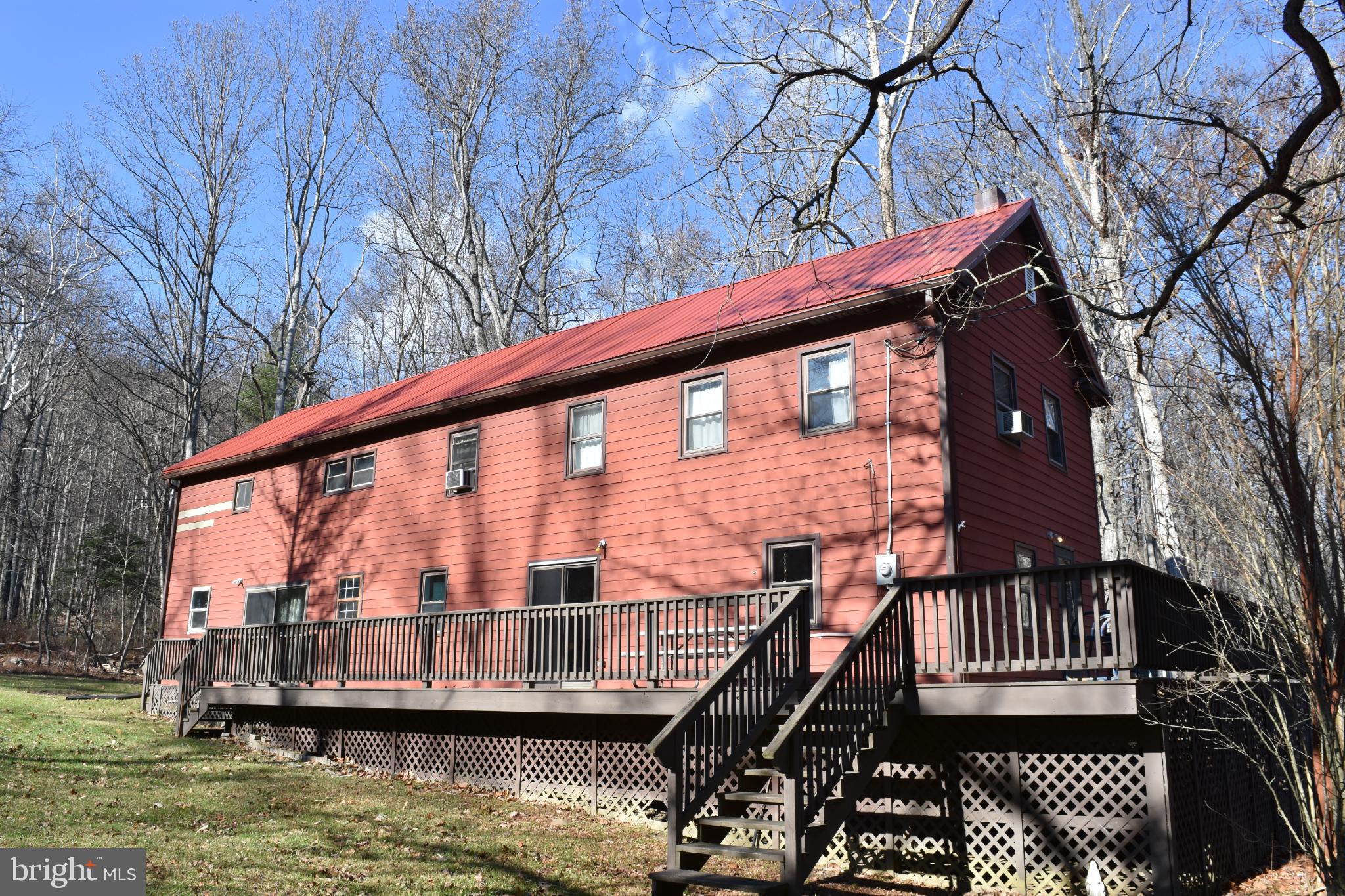 This charming 1930 Ranch/Farmhouse has a lot of potential! The spacious 2,816 sqft includes 3 bedrooms, 2 full baths, a kitchen/dining room, livingroom, and 2 large rooms both upstairs and down that you can make whatever you want. The large room downstairs is currently used as a family/community/activity room, and upstairs the large room is currently used as a large bunk room, but you could easily convert to your desires and needs. There's a LOT of room to customize and make your own. You might see a few old water stains, but the new metal roof in 2024 solved all known issues! Priced to sell as is.