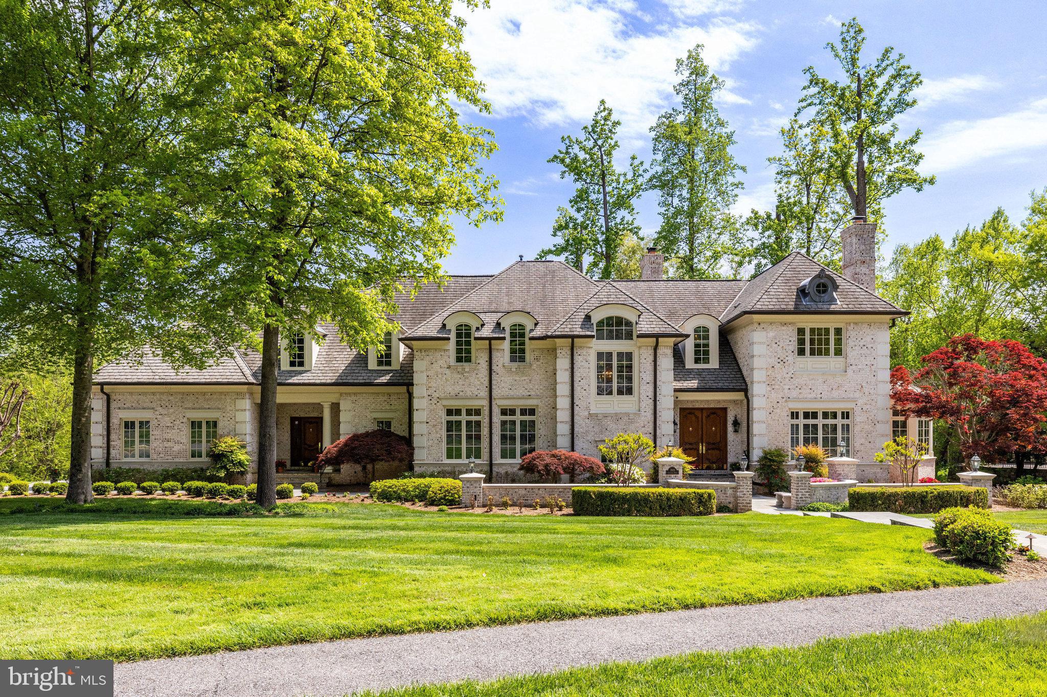 A true one-of-a-kind masterpiece – a custom home built by Masterpiece Custom Homes in The Reserve – the National Capital Region’s premier estate community.  Situated on a prime .91-acre corner lot, this home boasts over 9,000 square feet of pristine living spaces on 3 levels with 5 bedrooms, 5 full bathrooms and 2 half bathrooms.  Meticulously maintained by the original owners and thoughtfully updated from top to bottom in 2023 to reflect modern trends and styles.  This home is absolute turnkey.
A beautiful paver driveway, gracious bluestone walkway and manicured gardens lead to a distinguished façade created using only the finest building materials:  oversized brick with prominent corner stones, graceful arched dormer windows with copper roofing, copper gutters and downspouts, premium grand manor roof and handsome twin solid mahogany entry doors. 
The stately exterior sets the stage for the stunning sun-drenched interior, perfect for grand entertaining and everyday living. 
Once inside, the elegant entry welcomes guests with its sophisticated Italian marble flooring and Shonbek crystal chandelier.  Arched doorways on either side invite visitors to the living room on the right with its two-tier cherry fireplace mantel and the grand foyer on the left with its 20-foot ceiling, Palladian window, sweeping curved staircase to the upper level, and a second spectacular Shonbek chandelier.  Gleaming recently refinished hardwood floors glisten throughout the main and upper levels.  The grand foyer opens into the impressive great room with its floor to ceiling windows and two-story dry stacked stone fireplace.  The expansive gourmet kitchen adjoins the great room - a chef’s dream with professional appliances including side-by side Subzero refrigerators, custom Hagerstown kitchen cabinetry, quartz countertops, and a center island with seating for 4.  From the kitchen, the butler’s pantry with its Subzero wine cooler and second dishwasher leads to the refined dining room with its exquisite moldings and a third Shonbek crystal chandelier.  A home office, convenient to the kitchen, includes gorgeous built-ins for storage. The study with its distinctive double mahogany entry doors, private balcony, and mahogany built-in bookshelves completes the main level.
The opulent owner’s suite is on one side of the upper level and features a perfect tray ceiling, private balcony, his and hers walk in closets with custom built-ins and completely renovated spa quality indulgent bathroom.  Three secondary bedrooms finish the upper level, and all include ample closets and luxurious ensuite bathrooms. 
The walk out lower level with its new luxury vinyl flooring throughout is flooded with natural light from windows in every room and includes a recreation room, game room, home theatre with adjacent wet bar, home gym, bedroom, and full bathroom.
Finally, the incredible, expansive Costa Rican hardwood deck off the kitchen and great room invites dozens of guests to join in for champagne cocktails.