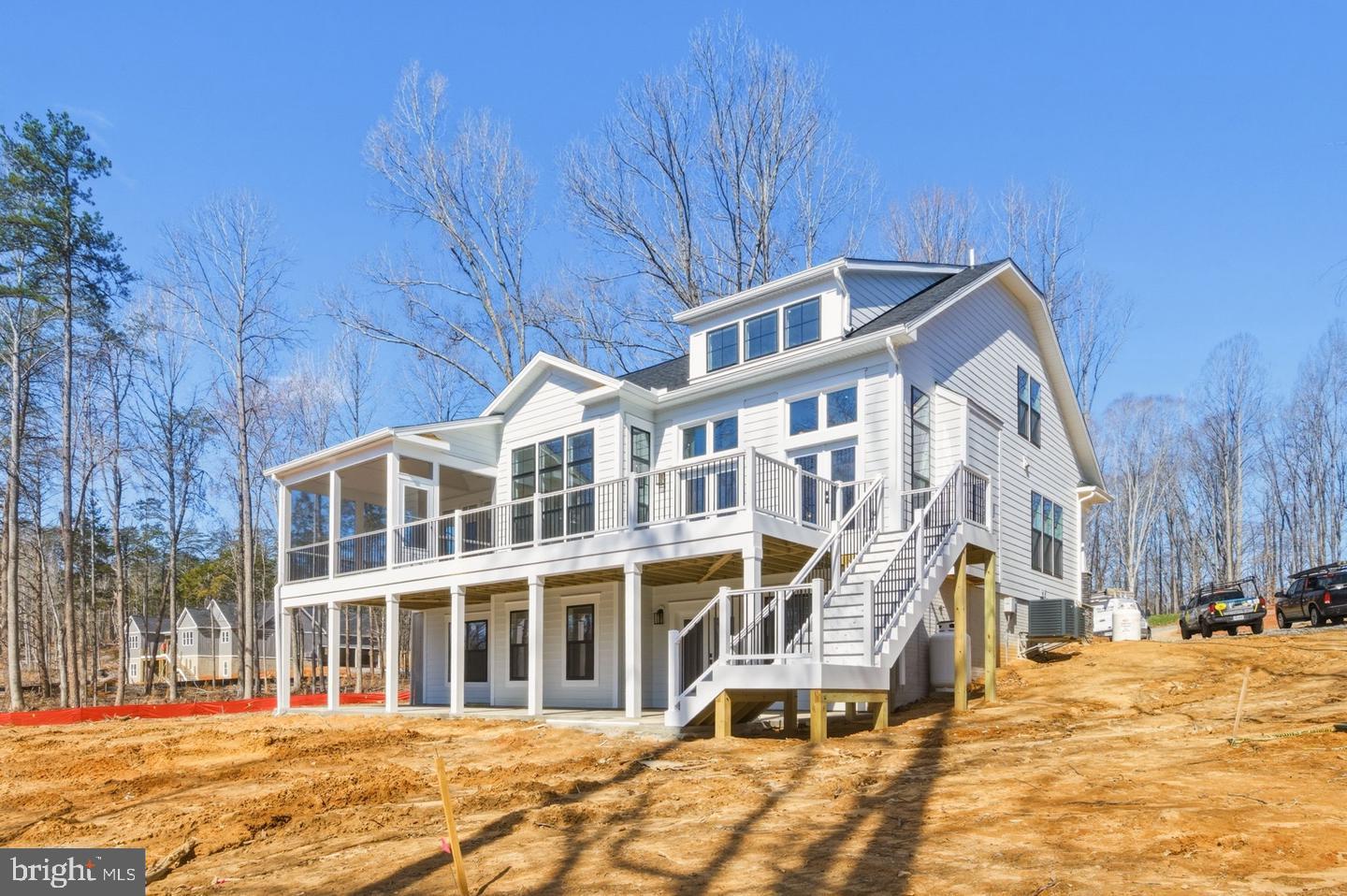 BRAND NEW COMPLETED 5-BEDROOM WATERFRONT HOME INCLUDING A NEW BOATHOUSE ON LAKE ANNA!! LIVE THE LAKE LIFESTYLE THIS SUMMER!!

Welcome to Compass Cove, Lake Anna’s newest waterfront community on the private side of the lake, where privacy, luxury, and breathtaking water views come together. Situated on a secluded 1-acre lot with over 120 feet of shoreline, this newly completed waterfront home offers approximately 4,600 square feet of beautifully designed living space and includes a brand-new boathouse.

Designed with both comfort and entertaining in mind, this popular floor plan features 5 bedrooms, 5 full bathrooms, and a 5-bedroom conventional septic system. The main level boasts an open-concept layout with soaring vaulted ceilings, a spacious family room with a cozy fireplace, and expansive windows that showcase stunning lake views year-round. The gourmet kitchen is appointed with quartz countertops, upgraded appliances, and ample space for gathering with family and friends. The luxurious primary suite serves as a private retreat, complete with a spa-inspired bathroom featuring ceramic tile, a frameless glass shower, a large walk-in closet, and direct access to the composite deck overlooking the water. A private study and an additional full bathroom are also located on the main level.
Upstairs, you'll find a charming loft overlooking the living area, along with two additional bedrooms connected by a Jack-and-Jill bathroom, perfect for family or guests. The fully finished walk-out basement offers even more living space, including a spacious recreation room with spectacular lake views, two additional bedrooms, and two full bathrooms. Step outside to the concrete patio and enjoy seamless indoor-outdoor waterfront living. The exterior showcases durable HardiePlank siding and upgraded black-framed windows, creating timeless curb appeal with a modern touch. Whether you're looking for a full-time residence or the ultimate lake retreat, this exceptional waterfront property offers the perfect combination of luxury, privacy, and access to everything Lake Anna has to offer. Don't miss the opportunity to make this brand-new waterfront home yours