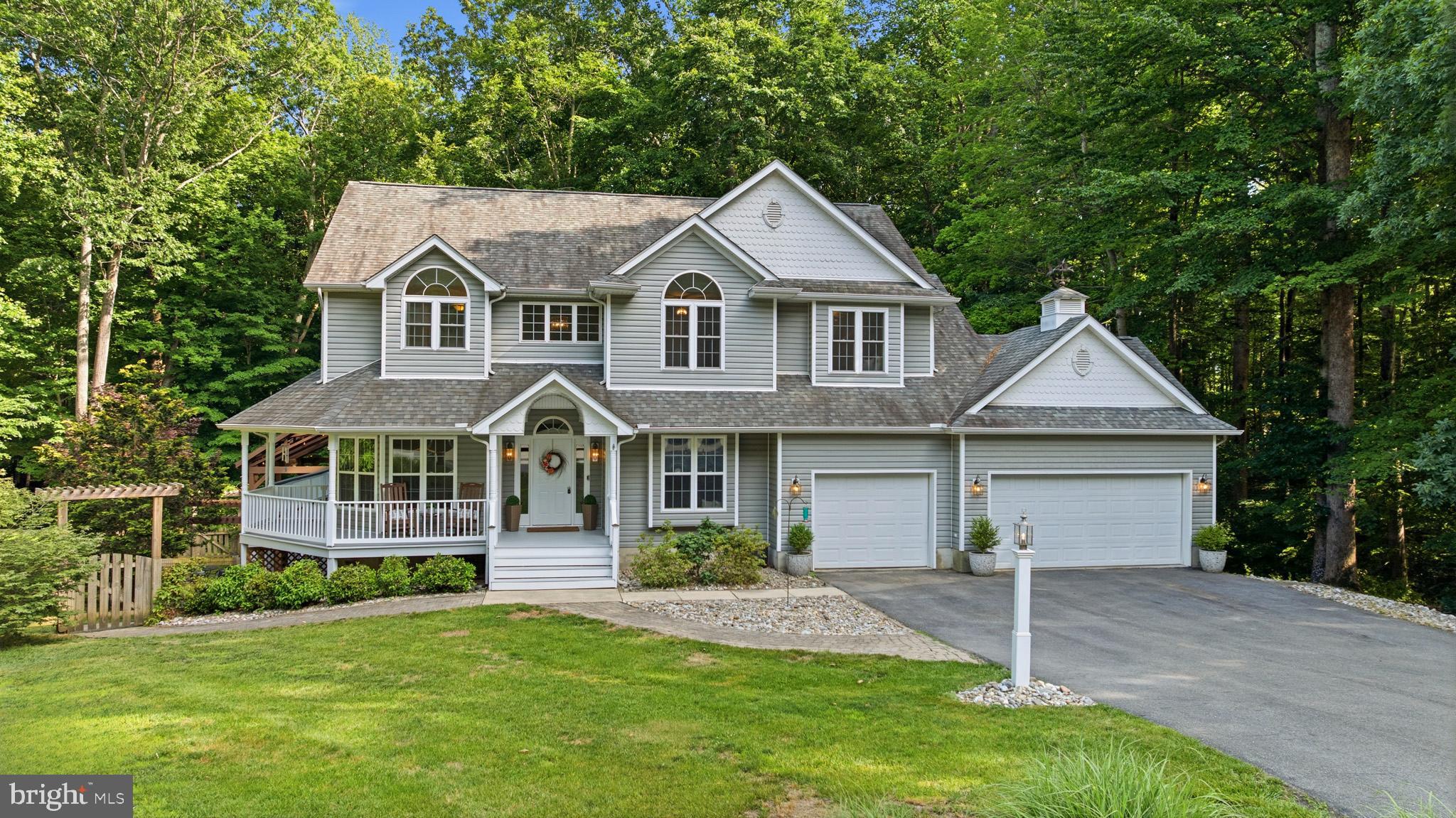 Welcome to this exceptional custom-built home in the highly sought-after Old Hundred community! Perfectly situated on a private 2.5-acre cul-de-sac lot in Northern Calvert County, this beautiful property offers the ideal combination of privacy, convenience, and timeless appeal. Surrounded by mature trees and lush landscaping, you'll enjoy a peaceful, park-like setting while remaining just minutes from shopping, dining, parks, commuter routes, and public transportation to Washington, D.C., Northern Virginia, Joint Base Andrews, and other surrounding cities. Offering over 4,200 square feet of finished living space, this home combines timeless charm with thoughtful updates throughout. The spacious floor plan features large gathering areas, abundant natural light, and a gourmet kitchen that will delight any home chef featuring a double oven, a gas cooktop, Quartz countertops, a tile backsplash, a pantry, and plenty of workspace for meal preparation and entertaining. The inviting family room is showcased by custom built-in shelves and a cozy gas fireplace, creating the perfect place to relax. A main-level fifth bedroom with an adjacent full bathroom provides flexible living options and is currently being used as a home office, making it ideal for remote work, guests, or multigenerational living. Upstairs, you'll find spacious secondary bedrooms and a primary suite that offers multiple closets and a beautifully updated spa-inspired bathroom. The conveniently located upper-level laundry room adds to the home's functional design. Outdoor living is exceptional with a welcoming wraparound porch, screened porch, expansive deck, and a stunning, roof covered swim spa. A pergola draped with flowering vines overlooks the stone patio, while the fenced side yard enhances both privacy and functionality. The partially finished, walkout basement offers endless possibilities with a recreation room with a second gas fireplace and ample space for a workshop, home gym, theater, or additional living area. Additional features include a three-car garage, built-in storage shed beneath the deck, fresh paint, and numerous updates throughout. Rarely does a property combine this level of privacy, charm, space, and convenience. Don't miss this opportunity to own this incredible home.