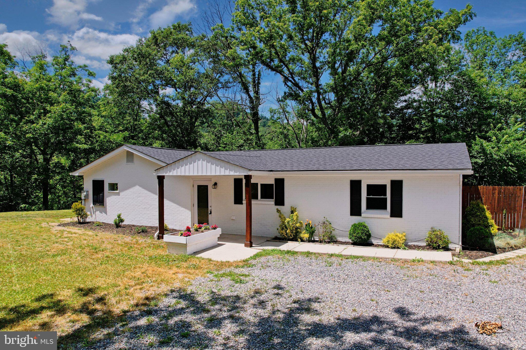 Welcome to The Modern Homestead. 

Just off Route 28 but tucked into a private setting surrounded by mature trees, this beautiful 3-bedroom, 2-bath rancher delivers the perfect blend of modern updates and everyday functionality. From the moment you arrive, the crisp white brick exterior, clean lines, and welcoming front porch create an inviting first impression.

Inside, you'll find a bright, contemporary interior featuring updated flooring, fresh finishes, and a stylish kitchen complete with white cabinetry, stainless steel appliances, and sleek tile backsplash. Everything, including the laundry room, is on one level. The open, comfortable layout is designed for easy living, whether you're hosting friends or enjoying a quiet evening at home.

The oversized garage provides exceptional space for vehicles, hobbies, storage, or workshop needs—offering the flexibility that is often hard to find.

Step outside and discover a backyard built for making memories. Cool off in the in-ground pool, relax in the hot tub after a long day, or gather with family and friends around your own private outdoor retreat. For those dreaming of a little homestead lifestyle, the chicken coop is already in place and ready for your feathered friends.