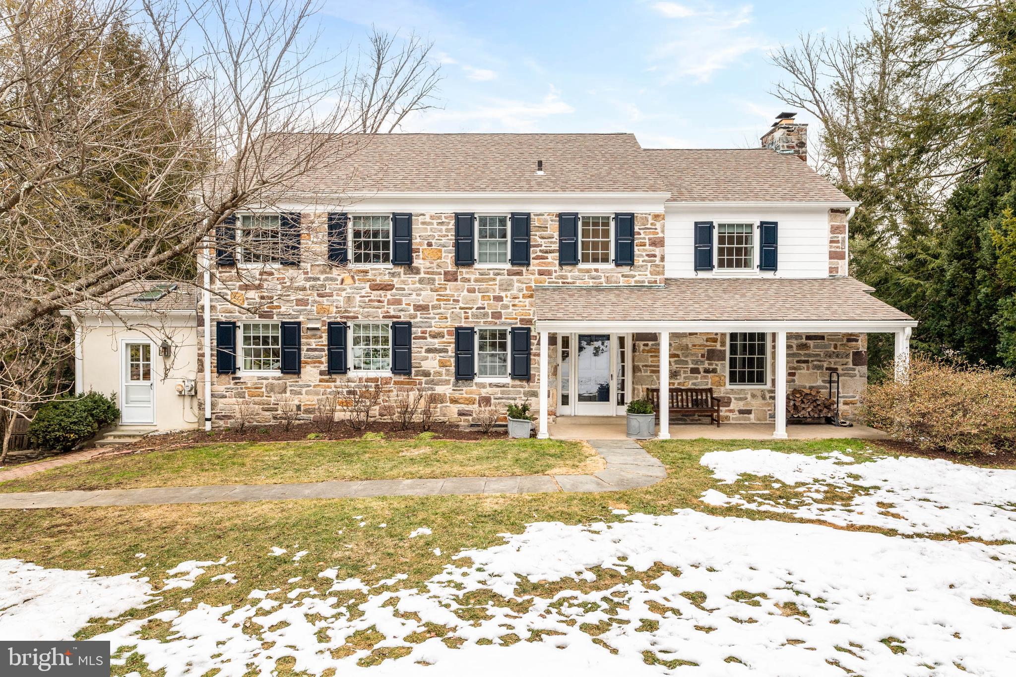 This enchanting stone colonial, located in a coveted North Bryn Mawr neighborhood,
offers sophisticated renovations and modern amenities that mirror the home's traditional
character. Situated on a private .8-acre property, this move-in ready 4-bedroom, 3.5
bath home has been thoughtfully updated and is ideal for both entertaining and
everyday life. The home boasts an open, inviting flow with two rear decks overlooking
the lush grounds and a welcoming covered front porch for relaxing outdoors.
Enter the home to the center hall and spacious, easy flowing main level.  The entrance
hall with half bath and hall closet, leads to a generously sized living room with a wood-
burning fireplace. The entrance hall continues to the renovated kitchen and bright sunny
family room. The kitchen is open to the dining room, with a large island and seating
connecting the two spaces. The kitchen can also be approached through the front
kitchen door into a mud room with built ins and radiant floor heating and sliders to a
deck, perfect for outdoor cooking. The kitchen was updated in 2019 with stainless steel
appliances, gas range, quartz countertops and large deep-silled windows allowing for
plenty of natural light inside.
The dining room offers a picture window with views of the expansive back yard and
mature trees. The adjacent family room has a gas fireplace, a wall of built in cabinetry,
lots of windows that flood it with light facing the gorgeous backyard, and doors leading
to the TimberTech deck (main deck and deck stairs installed in 2018). The 2nd level
includes a spacious primary suite with the recently renovated ensuite bath (2025), three
additional bedrooms and second full bathroom (renovated in 2025). Deep windowsills, timeless millwork,
and built-in shelving enhance the bedrooms. The large hall linen closet and pull-down
access to attic space allows for plenty of storage. The lower level is finished and
comprises of a family room, full bath, laundry, storage, a wall of windows and door to
the back yard. All new front windows, shutters, and gutters installed in 2020. Heating,
central air, and hot water systems replaced in 2021. The majority of the hardwood floors on the first floor were installed in 2019. Attached 2 car garage.
Ideally situated just minutes from downtown Bryn Mawr, the train station, parks, shops,
and restaurants — and located within the highly regarded Lower Merion School District
— this exceptional home combines privacy, convenience, and timeless appeal. Seller is a licensed Realtor in PA.