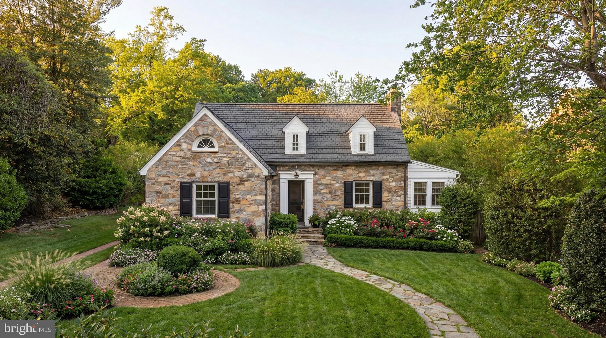 203 W Mason Avenue presents a rare opportunity to own a reimagined storybook home, where timeless charm meets a comprehensive, design-driven renovation and expansion in one of Alexandria’s most beloved neighborhoods.

Set in coveted Rosemont, the home captures the essence of classic cottage architecture while offering the ease and sophistication of fully updated living. Thoughtfully expanded and rebuilt by Akseizer Residential, the residence reflects a careful balance of craftsmanship, functionality, and elevated design.

A custom high-gloss lacquered mahogany front door creates a striking first impression, opening to interiors defined by rich, dark-stained oak flooring and a natural, flowing layout. The main level unfolds with intuitive connectivity, where the living room, anchored by a fireplace with a Carrara marble hearth and surround, transitions seamlessly into the kitchen and adjacent living spaces, creating an ideal environment for both everyday living and entertaining.

The kitchen serves as a true focal point, pairing custom cabinetry by Akseizer Residential with quartz countertops and an integrated stone sink. A Waterworks unlacquered brass faucet adds warmth and character, while a suite of Bosch appliances, including integrated refrigeration, dishwasher, and microwave, is complemented by a statement Ilve 40-inch dual-fuel range in a limited-edition white finish with brass hardware.

Upstairs, the home offers well-proportioned bedrooms thoughtfully arranged for both comfort and privacy, including a primary suite enhanced by custom built-in cabinetry. Bathrooms throughout reflect a cohesive and timeless palette, featuring white Carrara tile, custom vanities, and Waterworks polished nickel fixtures with frameless glass enclosures. The lower level extends the home’s functionality with additional living space, laundry, storage, and flexibility for a home office, gym, or media area, enhancing the home’s overall livability.

The home’s setting is a defining element of its appeal, thoughtfully conceived to create a seamless dialogue between indoor and outdoor living. A beautifully designed rear terrace and garden extend the interiors with effortless grace, offering an ideal backdrop for both quiet moments and refined entertaining. Tucked discreetly beyond, the detached garage introduces everyday convenience while preserving the property’s architectural integrity, charm, and sense of scale.

Updated HVAC systems, including a new central system and a dedicated Carrier mini-split for the rear addition, ensure comfort and efficiency throughout.

Ideally located near the shops, cafés, and community feel of Del Ray, and just minutes from Old Town Alexandria and commuter routes into Washington, D.C., the home also benefits from close proximity to highly regarded public and private schools, offering both lifestyle, accessibility, and long-term value in equal measure.

A rare opportunity, 203 W Mason Avenue delivers the charm of a storybook cottage with the scale, design, and livability of a fully modern home.