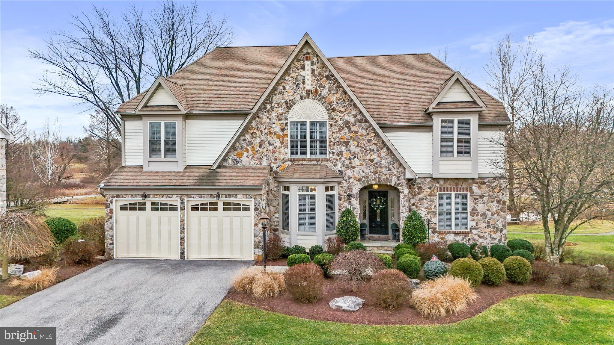 Experience timeless luxury at 33 Louisa Beall Ln. 
Set within the gates of the prestigious Beallair Community Conservancy, this exceptional 4-bedroom, 3.5 bath former model home offers timeless elegance in a setting rich with American history. Beallair takes its name from the original Washington family plantation established in the late 1700s, and today the community preserves its legacy through a surviving historic mansion, carriage house, and manicured gardens—now enjoyed as part of the community’s common grounds. A tree-lined entrance, park spaces, scenic walking trails, and future plans for a clubhouse, pool, and picnic areas complete this thoughtfully designed enclave. 
From the moment you enter, the home impresses with a grand foyer, refined architectural details, and luxurious finishes throughout. Oak and cherry hardwood flooring, crown molding, and expansive windows create a warm yet sophisticated atmosphere. The main level offers a private office, elegant sitting room, and a breathtaking family room featuring soaring ceilings, skylights, a stone gas fireplace, wet bar, and walls of windows that flood the space with natural light. A whole-house surround sound system, including the upper-level deck, ensures seamless indoor-outdoor enjoyment.
The gourmet kitchen is designed for both entertaining and everyday living, showcasing granite countertops, a large center island with breakfast bar, double wall ovens, and a five-burner cooktop. The kitchen flows seamlessly into the sunlit dining room, with a conveniently located laundry room just off the kitchen. 
The main-level primary suite is a private retreat, complete with a sitting area, dual closets including a walk-in, and a spa-inspired en suite bath featuring a jetted soaking tub, walk-in shower, and marble vanity.
Upstairs, a spacious loft with built-in shelving and balcony overlooks the grand living spaces below. Three generously sized bedrooms share a fully upgraded bath with marble vanity and elegant tile flooring and walls.
The fully finished lower level offers an additional level of luxury living, including a large entertainment lounge, full wet bar with wine storage and cooler, as well as a private movie room with its own dedicated surround sound system for a true home theater experience. A standout spa suite showcases Italian tile, an oversized jetted soaking tub, dual vanities, a large walk-in shower, a sauna, and adjoining exercise room with custom vanity.
Outdoor living is equally impressive. The beautifully hardscaped and landscaped patio and expansive upper-level deck overlook a peaceful creek and nearby walking trails, providing a serene backdrop for relaxation or entertaining.
This one-of-a-kind residence combines historic surroundings, refined luxury, and modern comfort—offering an unparalleled lifestyle in one of Jefferson County’s most distinguished gated communities!