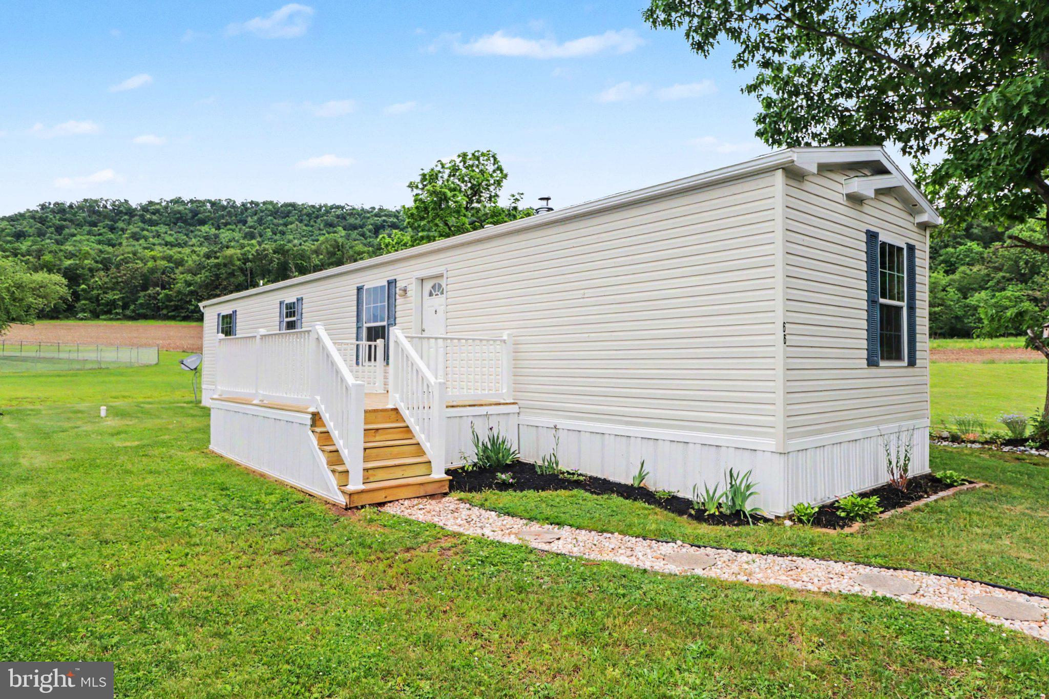 Tucked into a quiet end-of-road setting in Halifax Village, this 2019 Redman mobile home offers the kind of peaceful backdrop that makes everyday living feel a little more open and relaxed. With views of neighboring farmers’ fields and the mountains beyond, this 2-bedroom, 2-bath home gives you a sense of space and privacy that is hard to find at this price point.

Inside, the home features comfortable one-floor living with an open main living area, a functional kitchen, and a split bedroom layout that provides privacy between the bedrooms. The primary bedroom includes its own full bath and walk-in closet, while the second bedroom and full hall bath offer flexibility for guests, hobbies, or a home office. The kitchen includes a gas range, refrigerator, dishwasher, and plenty of cabinet space, opening naturally into the main living area for an easy everyday flow.

Outside, enjoy a newer front deck, refreshed landscaping, off-street parking, and a large shed with electric — ideal for storage, tools, or workshop space. The home also features central air, propane forced-air heat, public water, public sewer, and main-floor laundry.

Simple, affordable, and quietly positioned with open country views — 66 Kip Road is a great opportunity for buyers looking for low-maintenance living in a peaceful Halifax setting.
