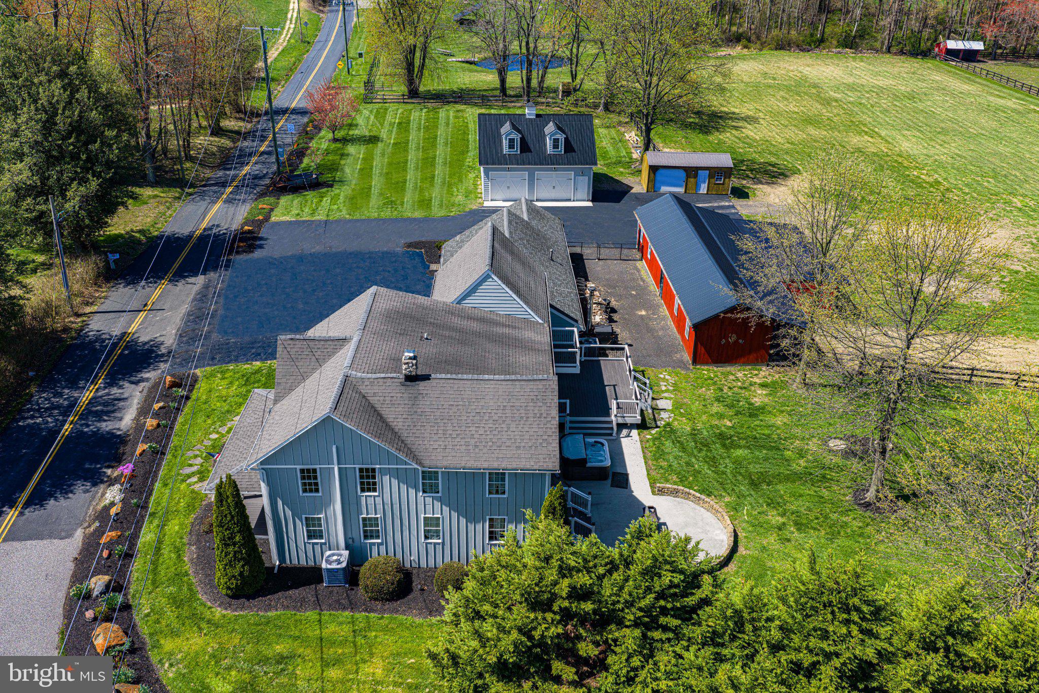 Setting on 4.83 +/- country acres, this charming and unique farmette offers the perfect blend of rural living and modern convenience. Ideally located near state routes and only 10 minutes to I-95, commuting to Baltimore or Washington, D.C. is convenient while still enjoying country living. The updated 4-bedroom, 3 full bath American farmhouse beautifully combines historic character with modern upgrades, creating a warm and inviting space for everyday living. Master suite has own private sundeck overlooking rear yard, walk-in closet, private master bath with two person shower with 4 shower heads and river rock floor, heated tile bathroom floor, smart mirror, large vanity, and smart toilet with heated seat and bidet. 2nd floor laundry (Washer/Dryer Included with Sale.) Property is served by 400 AMP Electrical Service to ensure plenty of power for house/building and future expansion. Dual Zone Heating/Cooling with backup Outdoor Wood Furnace and Pellet Stove (Both Included with Sale.) This property is a dream for Homesteading, Gentleman Farming, Horse Enthusiasts and Car Enthusiasts, or anyone seeking a versatile lifestyle. A spacious 4-car heated attached garage includes electric vehicle charging, while the impressive 28'x30' detached garage (built in 2020) is fully equipped with a vehicle lift, air compressor, tire changer, tire balancer, workbench, and ample tool and storage cabinets, plus storage loft with stairs. This detached garage was built using 6"x6" construction, 12' Ceilings, and finished with high grade materials. The level, fully usable land features fenced pasture/paddock areas and a well-appointed barn with three stalls, a covered run-in, chicken coop, equipment storage, and workshop space—ideal for small-scale farming or equestrian use. Outdoor living is equally exceptional, with a spring-fed pond complete with fountain and lighting, a pier, and a large picnic area perfect for relaxing or entertaining. The fully fenced backyard includes a composite deck (2021), patio, hot tub (2024), fire pit, and a fenced garden space. This one-of-a-kind property truly checks all the boxes—offering space, functionality, and charm in a highly convenient location. The house also has historical provenance, Known as the John Bailey House(HA-0923.) It is a Harford County Historic Landmark. This property reflects the county’s rich architectural and cultural heritage.Harford County historic landmark designation is often misunderstood, but it can be beneficial for property owners. The designation may provide valuable tax incentives and financial benefits while primarily regulating only exterior modifications visible to the public. Property owners are free to renovate, remodel, or make changes to the interior living spaces without any limitations. Large Improvements already completed include replacement windows, new Hardie board siding installed in 2021, along with new battens and decorative gingerbread trim.