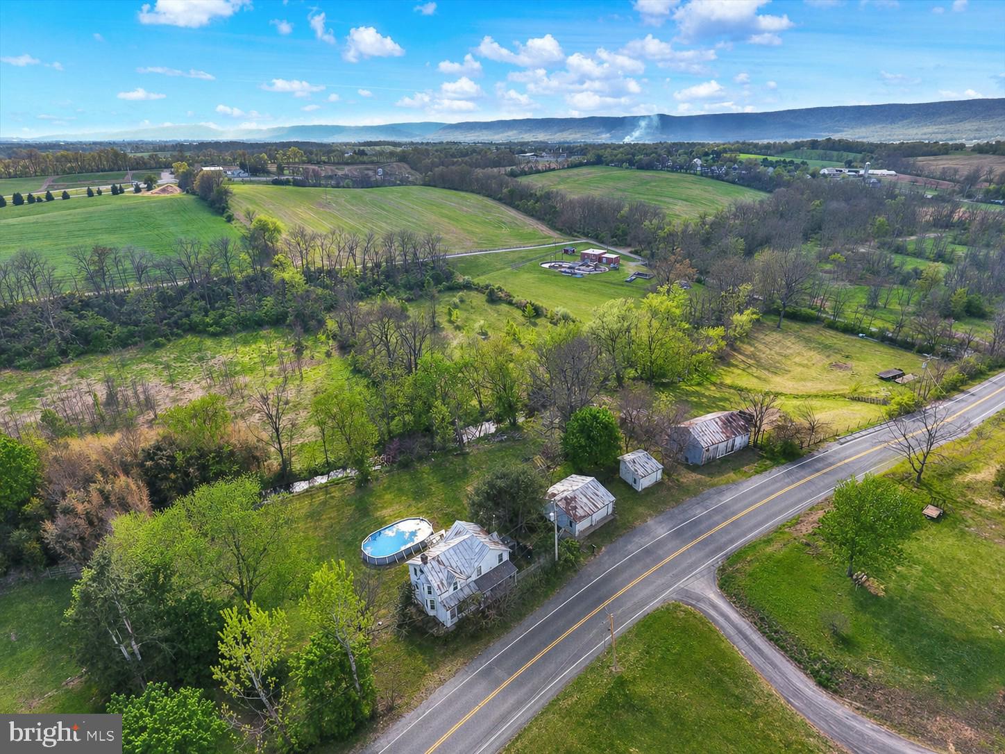 A 7-acre farmette in two parcels with the Newburg Run flowing thru the property. The 4-bedroom, 2.5 bath home sits on a 0.79-acre parcel with private well and public sewer, while the adjoining 6.31-acre parcel features a barn, garage, and chicken pen—ideal for hobby farming, animals, or extra storage. A stream runs through the backyard, adding to the setting, along with an above-ground pool for summer enjoyment. Plenty of room for pets and children to spread out and enjoy the outdoors. Two separate parcels provide options for future use or building. A walking trail borders this property connecting it with the 32-acre Hopewell Township Park with hiking, disc golf, baseball and more. Located just 5 minutes to the Blue Mountain Turnpike Interchange and 15 minutes to Interstate 81, making commuting easy while still enjoying local hometown conveniences. Room to live, room to grow—come take a look.