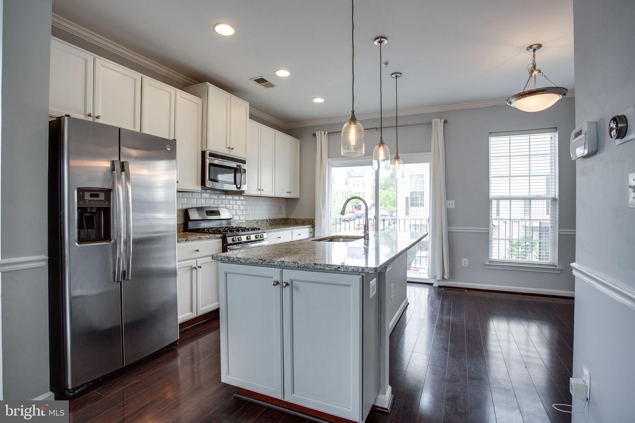 Bright, modern, and beautifully maintained, this 3-bedroom, 2.5-bath townhome-style condo in sought-after Gallery Park offers both style and convenience. Enjoy an open-concept main level featuring gleaming hardwood floors, a spacious granite island, white shaker cabinetry, subway tile backsplash, and elegant pendant lighting—perfect for everyday living and entertaining. The upper levels include three well-sized bedrooms, contemporary ceramic-tile bathrooms, and ample natural light throughout. Additional perks include a one-car garage with tandem parking for two total vehicles, providing rare extra space for this community. Ideally located close to shopping, restaurants, parks, and major commuter routes, this home offers comfort, accessibility, and modern living all in one and the association just replace the roof