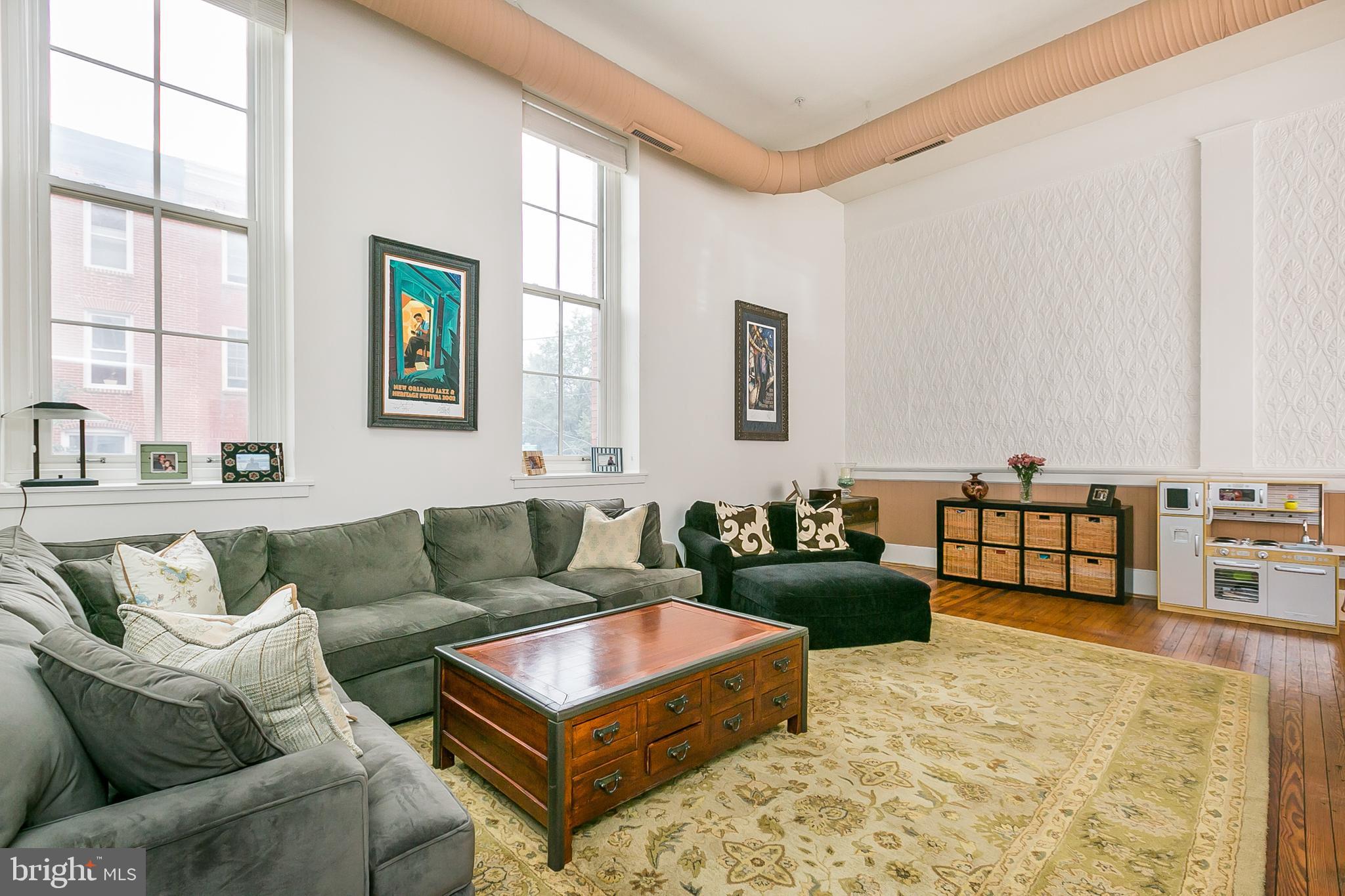 Tribeca Meets Baltimore!  Freshly painted, contemporary, loft-style condo  in a historic building with unique architectural features and walls of windows.  Highlights include an open concept floor plan with large , open living areas, a separate dining area, 15 foot ceilings, expansive windows, hardwoods, fabulous closets and 2 very spacious storage areas not found in all units.  New HVAC was installed 2018.  Private, covered garage parking  and an elevator just outside your door make for ease of living.  Located in the heart of Federal Hill and close to the newly updated Cross Street Market, Federal Hill and Riverside Parks, the offerings around the Inner Harbor and very quick access to I 95 and  the MARC train.