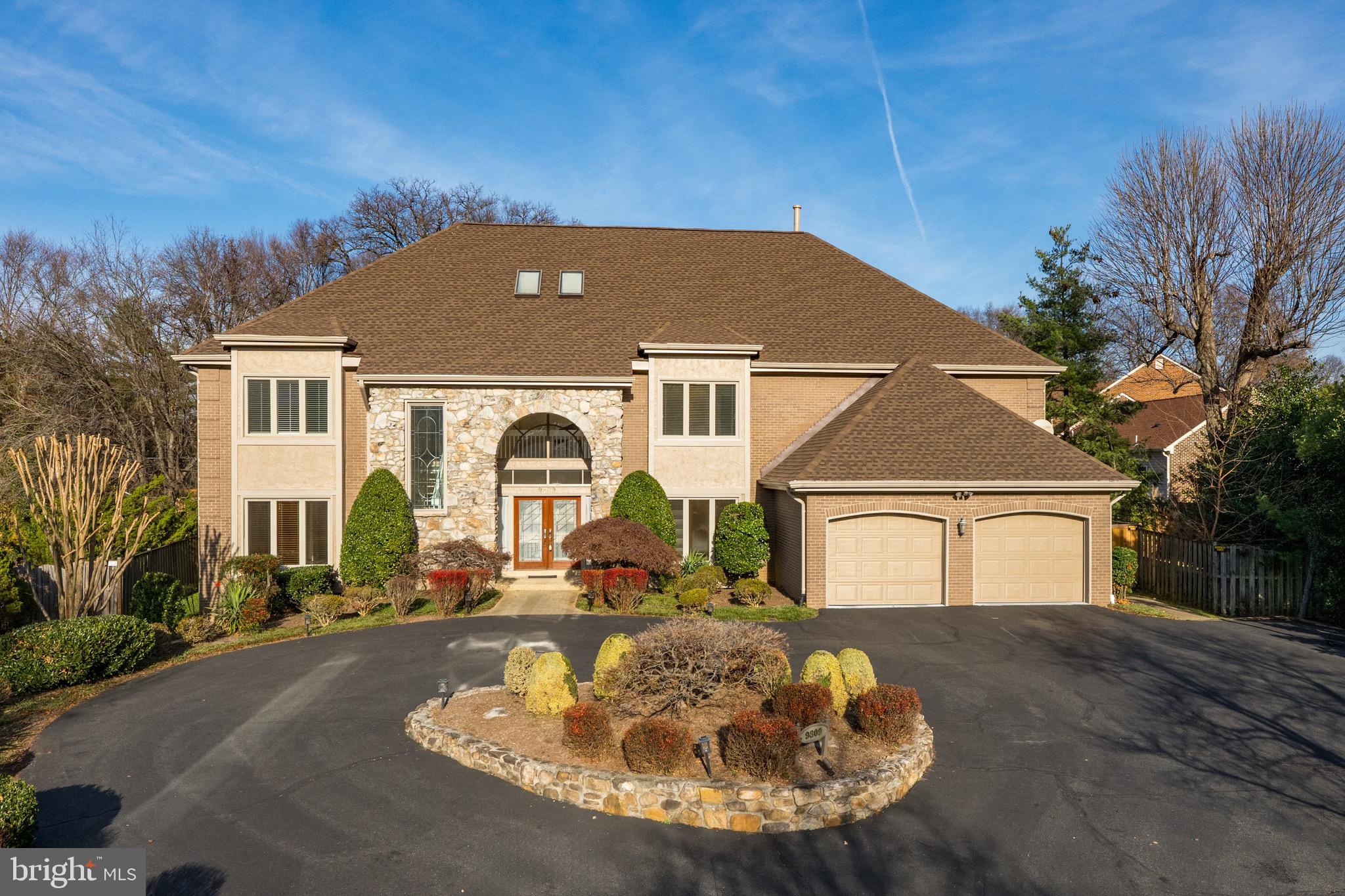Introducing 9809 Tibron Court, an exceptional brick residence tucked away on a quiet cul-de-sac just moments from the Potomac Village in Potomac, Maryland.  A sweeping circular driveway sets the stage for this stately residence, framed by lush, professionally landscaped grounds. An arched entryway and stone façade lead to the grand double-door entrance, welcoming you inside. The open foyer, adorned with marble flooring, is flooded with natural light streaming through oversized windows. Continue into the great room, the true centerpiece of this home. This room features a paneled vaulted ceiling, gleaming hardwood flooring, custom built-in cabinetry, and floor-to-ceiling windows overlooking the manicured backyard. The sunroom offers a relaxed lounge area for seamless indoor-outdoor entertaining, enclosed by walls of windows and positioned directly adjacent to the pool. The spacious kitchen is a standout within the home. Equipped with top-of-the-line stainless steel appliances, dual sinks, warming drawer, and center island, meal prepping and entertaining is - effortless. Beyond the kitchen lies a thoughtfully designed mudroom, featuring floor-to-ceiling custom built-in cabinetry to keep everyday essentials neatly organized and out of sight. Offering direct access to the two-car garage, and its own convenient powder room, this highly functional space is a hidden gem within the home. The dining area connects seamlessly to the kitchen through a butler’s door, and is well suited for hosting larger gatherings. Built-in cabinetry provides ample storage for china and serving pieces, while windows overlooking the front yard fill the space with natural light. What makes this floor plan truly distinctive is the main-level bedroom, complete with a full en-suite bathroom featuring a walk-in shower. The bathroom conveniently connects both the bedroom and a well-appointed main-level office, ideal for those working remotely. Featuring built-in cabinetry, the office provides a highly functional at-home workspace. Ascend to the upper level, where four bedrooms and a gracious laundry room await. The primary suite serves as a private retreat, featuring a tray ceiling, a newly renovated bathroom, a light-filled dressing room, and multiple closets. The renovated primary bathroom showcases a custom-tiled walk-in shower, soaking tub, and dual vanities, while the dressing room and closets provide generous square footage enhanced by abundant natural light. Continue down the hall, where the remaining three bedrooms and the upper-level laundry room are located. Each auxiliary bedroom offers a sizable footprint and ample closet space —one features an en-suite bathroom, while the other two share a Jack-and-Jill bath. The sweeping laundry room is highly functional, equipped with front-loading washer and dryer, a utility sink, and abundant countertop space for folding and organization. The lower level of this home offers tremendous flexibility for additional living and entertaining space. An oversized recreation area is centered by a gas fireplace with a stone-surround, and complemented by a wet bar with a beverage refrigerator. A versatile bonus room functions beautifully as a home gym or media room. A sixth bedroom is conveniently connected to a full bathroom, while abundant storage can be found in the utility room. Outdoor entertaining is equally impressive with a fabulous pool, expansive patio, and outdoor deck. The newly fenced 0.63-acre lot is a rare find for the area, and a brand new roof was installed last year. 9809 Tibron Court is truly a standout within the neighborhood, and a special offering in a coveted location. Just steps from the Potomac Village, and easy access to I-495, this home is ideally positioned in the heart of Potomac. With its unique features and prime setting, this home is not expected to remain on the market long.