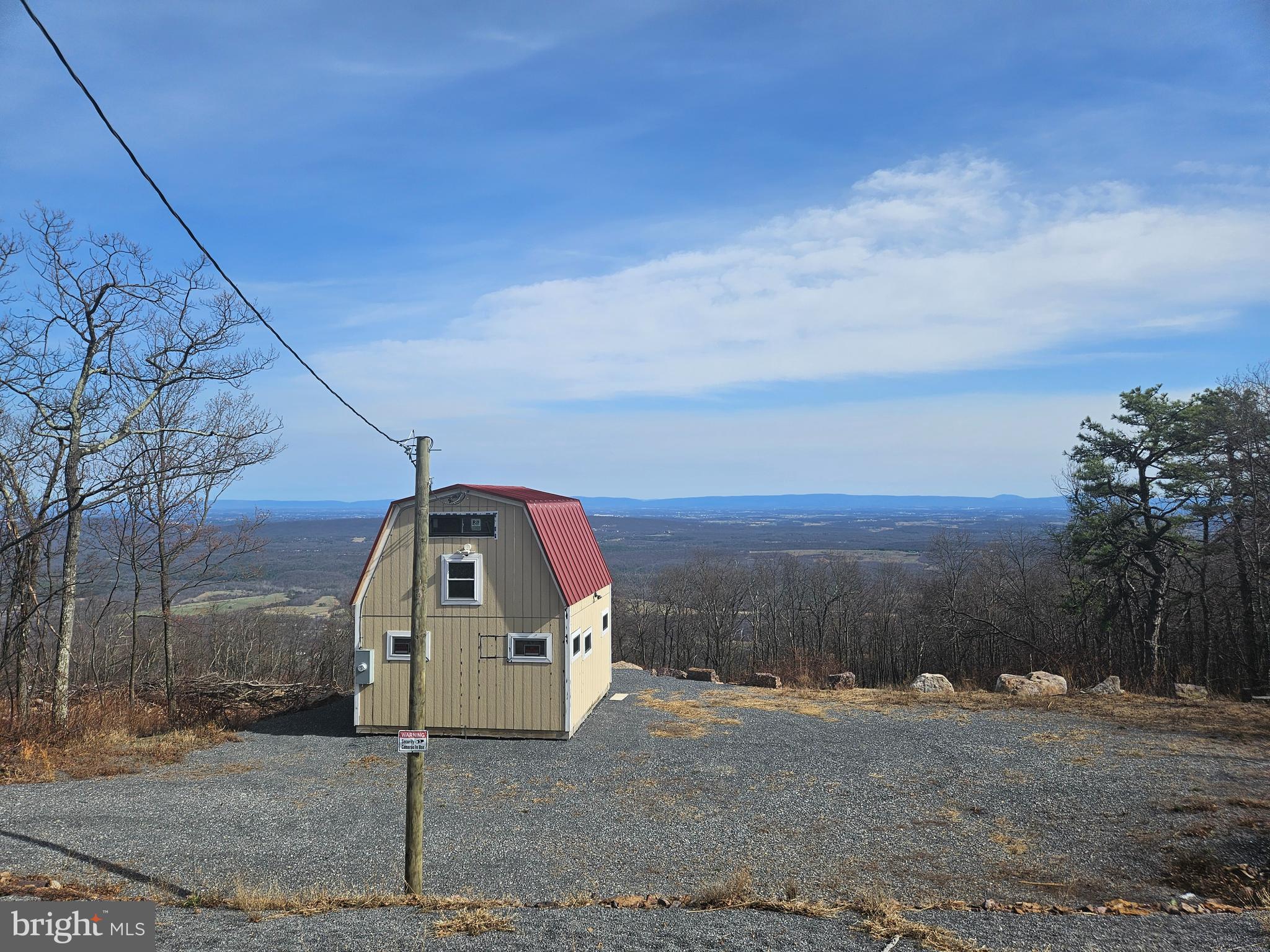 More Pictures On The Way! Now Offering This Beautiful Lot In Shawneeland VA, Just West Of Winchester! Mountain Top Lot With Great View! Lot Is Cleared, and Neighbors Lot Is Also! Clear View Of The Winchester City Area And Beyond!
This .44 Acre Lot Has A Cleared Area With A Standing Shed, A 3 Bedroom Septic Perk, And Power Is Already Run On This Road. Mountain Top Living Includes The Frederick County Sanitary District To Take Care and Maintain The Roads Year Around. Its Not In An HOA) All Rules And Regulations Are Set By Fredererick County  VA. Sanitary District Means That Frederick County  Employs People To Keep Roads Clear In All Seasons, Mow The Common Areas, Keep Playground And Lake Beach Areas Clean, Keep Mailbox Areas Clean And Repaired and More! Internet Is Available At The Top Of The Mountain From Several Resources: Plenty Of People Work From Home In The Subdivision. Make Appointment Today