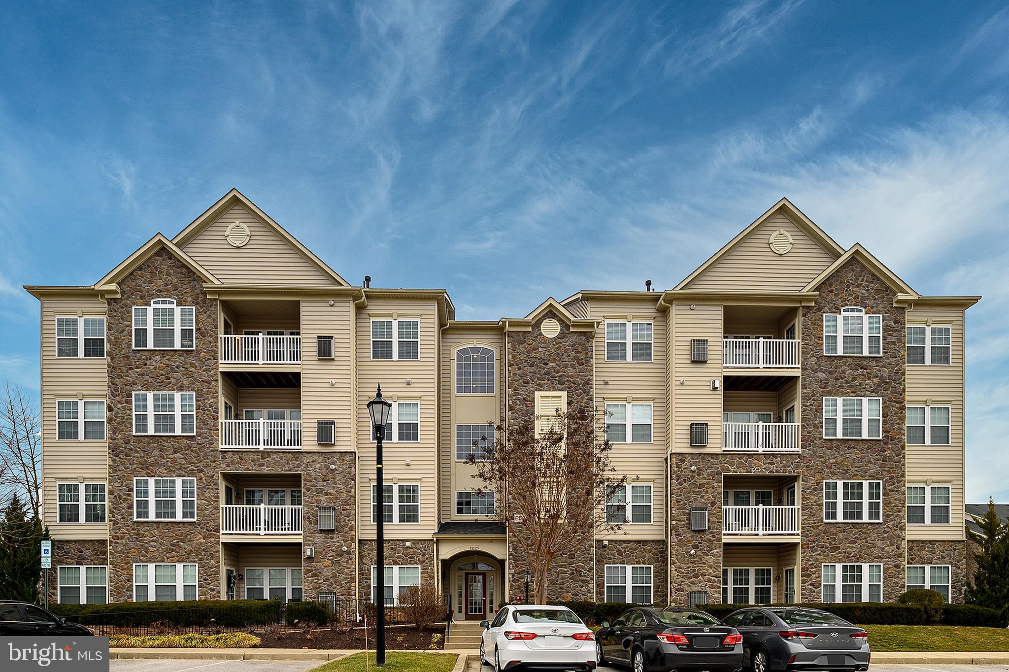 Enjoy a carefree lifestyle in this 55+ condo in sought-after Waverly Woods East.   This top floor condo with two bedrooms and two bathrooms boasts soaring ceilings and a southern exposure that fills the uint with natural light!  Great features include neutral paint and upgraded carpet throughout; kitchen with 42' oak cabinets, Corian countertops and upgraded appliances including a Bosch dishwasher; relaxing breakfast area with ceramic flooring; spacious living room with vaulted ceilings and a cozy stone fireplace; formal dining area with crown molding and chair rail; large primary suite with vaulted ceilings, sitting area, a large walk-in closet and a private bath with double sink/vanity; convenient, full size washer and dryer in the unit; ample storage including an in-unit storage room and a building storage area.  Enjoy the outdoors on your private balcony or take advantage of the great community amenities including a pool, clubhouse, tennis/pickleball court and an exercise room!  Recent mechanical updates include Bosch dishwasher in 2023, AC replacement in 2022, microwave in 2021,  and water heater replacement in 2019.