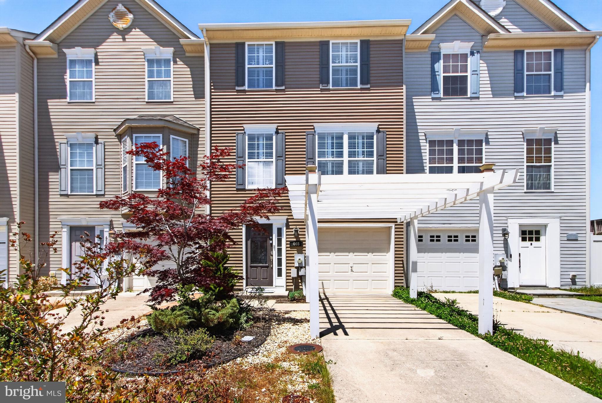 Welcome to 448 Ocean Court, a truly one-of-a-kind townhome in the heart of Milton where designer finishes, thoughtful renovations, and exceptional outdoor living come together. This stunning three-level residence offers 3 bedrooms, 2 full baths, 2 half baths, and over 1,700 square feet of beautifully updated living space designed for both everyday comfort and effortless entertaining. 
The main level showcases an open-concept floor plan highlighted by rich hardwood flooring, plantation shutters, and modern cable railings. The gourmet kitchen is a showstopper, featuring stainless steel appliances, double wall ovens with convection, a GE Café refrigerator with built-in Keurig, cooktop, pantry, tiled countertops and backsplash, and an oversized breakfast bar with seating for six. Double sliding doors flood the space with natural light and lead seamlessly to the outdoor entertaining areas. 
The lower level offers incredible flexibility with a spacious recreation room centered around a striking 74-inch linear fireplace, Nebula Home Theater Projector, an additional bedroom, half bath, and laundry area. Upstairs, you'll find two private owner's suites, each featuring walk-in closets and beautifully customized en-suite baths with frameless glass showers and dual shower heads. 
Step outside to your own private oasis, complete with an expansive deck, patio, mature landscaping, and generous backyard space—perfect for entertaining, relaxing, or enjoying coastal evenings.Backyard has brand new shed for storage with workbench.  Recent exterior upgrades include new siding, shutters, and a charming pergola framing the driveway. Best of all, there are no HOA fees, providing added flexibility and value. 
Ideally located just minutes from downtown Milton, Lewes and Rehoboth beaches, restaurants, parks, entertainment, and Delaware's tax-free shopping, this move-in-ready home offers the perfect blend of luxury, convenience, and coastal charm.