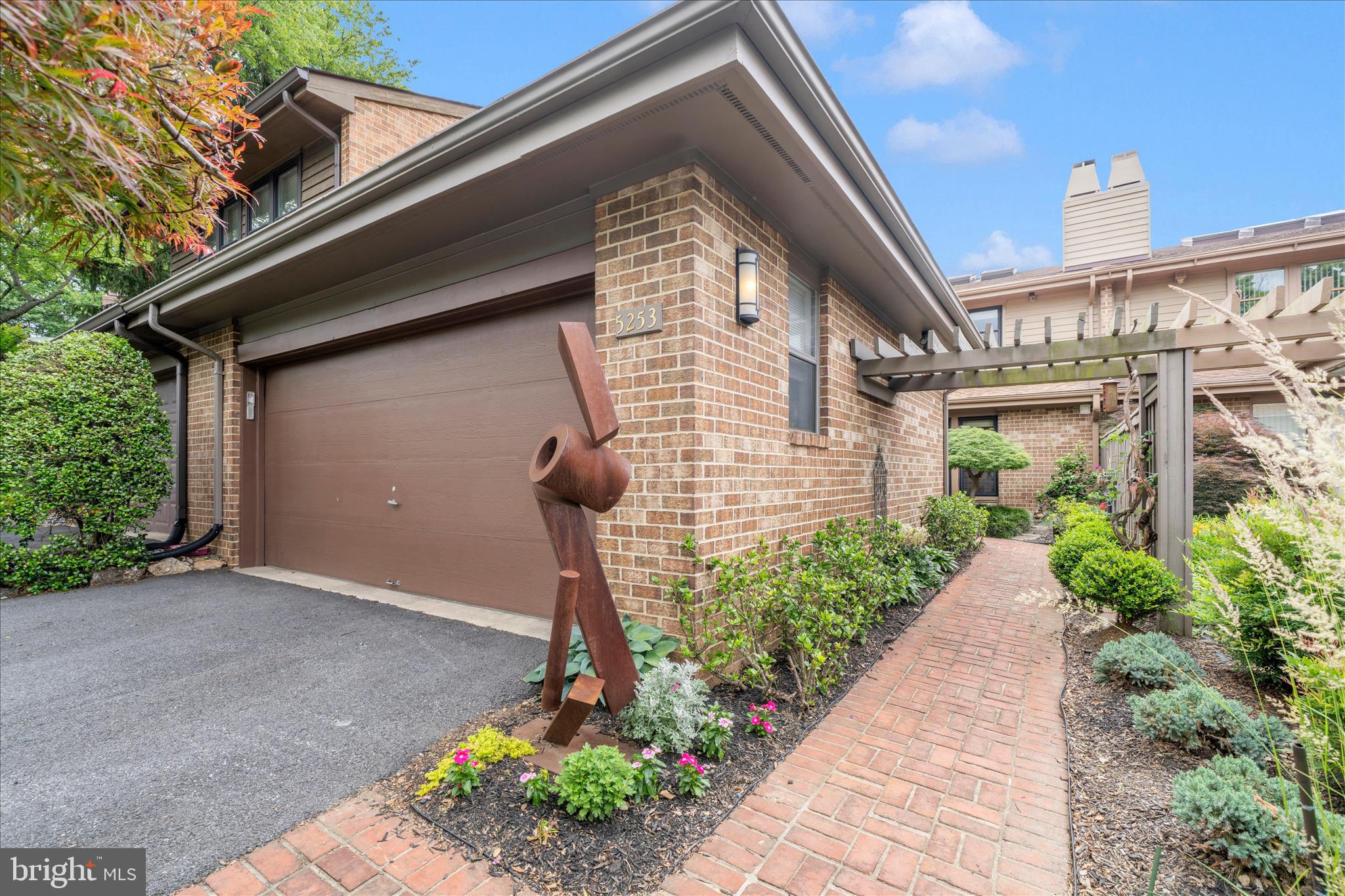 Located in a highly sought‑after community, this beautifully updated home impresses from the moment you arrive. A brick walkway framed by lush, mature landscaping sets the tone for the inviting spaces inside.

The open main level features a dramatic two‑story ceiling with skylight, a welcoming living room with gas fireplace and custom built‑ins, and an adjoining dining area—an ideal layout for everyday living and entertaining. The bright, white-on-white center‑island kitchen offers table space, updated finishes, a separate laundry room, and access to the fenced rear patio, creating your own private outdoor retreat. This level also includes a full bath and a versatile den that can easily serve as a bedroom.

Upstairs, the oversized primary suite offers two generous walk‑in closets (6'X7' each) and a thoughtfully renovated spa‑inspired bath with separate soaking tub, large shower, and dual vanities.

The finished lower level is full of character, featuring built‑ins, a bar area, a spacious recreation room, a dual‑entry full bath, and an additional den or guest room.

With a newer roof and HVAC system, this home has been exceptionally well maintained and updated. The 2-car detached garage is so convenient for parking.  The prime location places you just minutes from Grosvenor Metro, Georgetown Prep, the Strathmore Mansion and Music Center, and provides easy access to 495, 270, and abundant shopping and dining.

This is one you won’t want to miss.