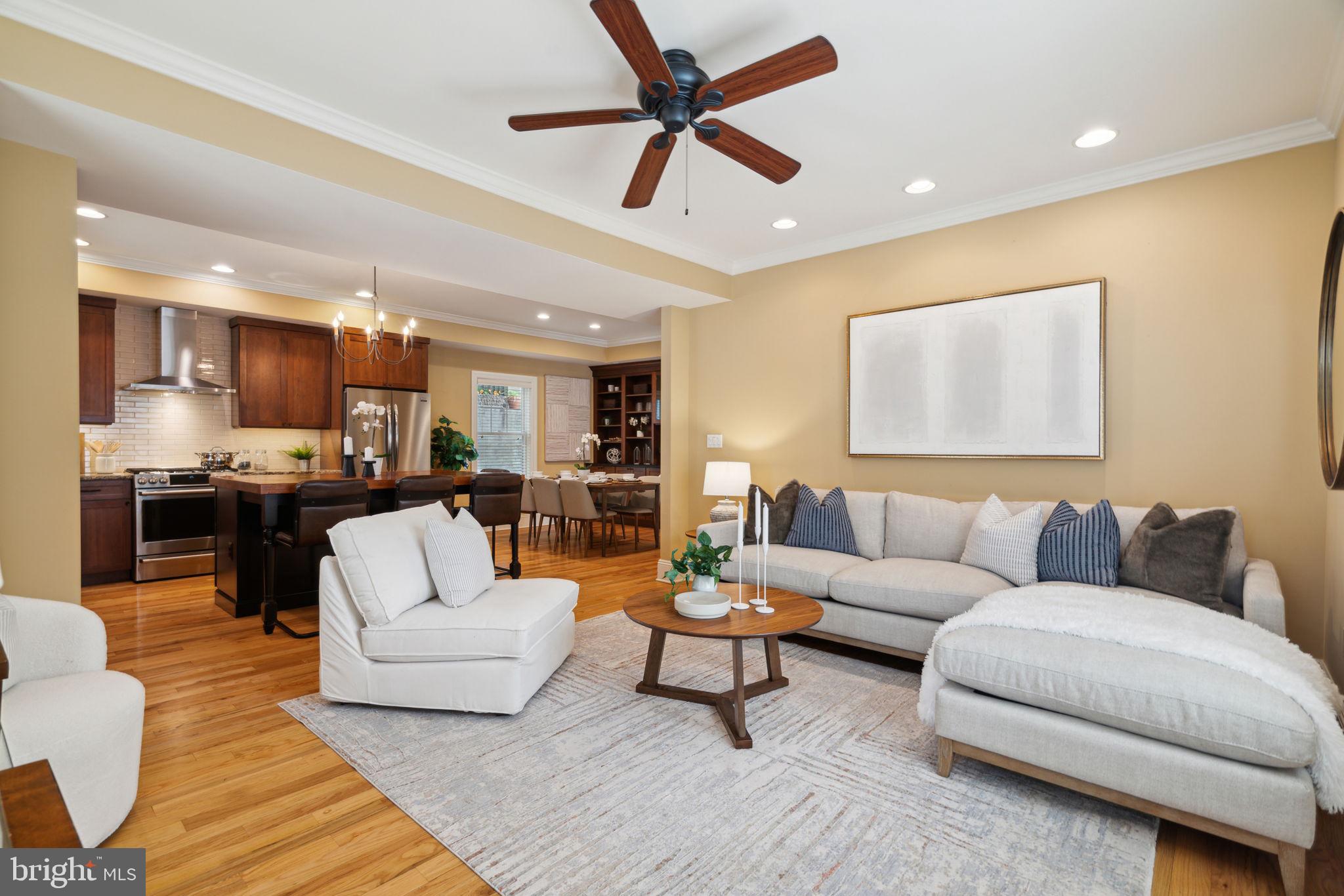 This expansive, turnkey four-bedroom, three-and-a-half-bathroom residence lives like a suburban home with a great layout, private outdoor space, and an attached garage on a tree-lined Queen Village block.
Built in 2004 and beautifully renovated since, this freestanding abode features four levels of elegant living space filled with gleaming hardwood floors, handsome millwork, and bright windows on three exposures. The first floor greets guests with a gracious foyer and direct interior access to the garage. A bedroom on this level is joined by a full bathroom and a patio, making it ideal for guests or home office use. 
A beautiful staircase flanked by wainscoting ushers you to a main level perfect for relaxing and entertaining. Enjoy a corner sun-splashed living room, and a separate dining area lined with a wall of built-ins. The updated gourmet open kitchen impresses with custom cabinetry, stone countertops, tile backsplashes, and a furniture-style center island/breakfast bar. Cooking is a joy thanks to the suite of stainless steel Dacor and Miele appliances, including a gas range, French door refrigerator, cabinet-front dishwasher, wall oven, and built-in microwave. A convenient powder room and large pantry complete this well-planned level. Above, two large secondary bedrooms enjoy roomy closets and access to an updated windowed bathroom and a laundry closet with storage. Head to the top level to discover your full-floor owner's suite, a serene oasis with a sprawling king-size layout featuring a fireplace, excellent closet space, and a renovated en suite spa bathroom with radiant heated floors. A gorgeous brick façade and planter boxes add wonderful curb appeal to this stately home, and new systems, including water heater and dual-zoned HVAC keep maintenance to a minimum. This exceptional Philadelphia neighborhood, where Queen Village meets Bella Vista, boasts outstanding walking, biking, and transit scores and great proximity to some of the city's best shopping, dining, and nightlife. On the surrounding blocks, you'll find the beloved Italian Market, parks and playgrounds, and a fantastic array of international cuisine. Whole Foods and Center City amenities are minutes away, and transportation is a breeze thanks to excellent bus service, the expressway, and SEPTA and PATCO trains all nearby.