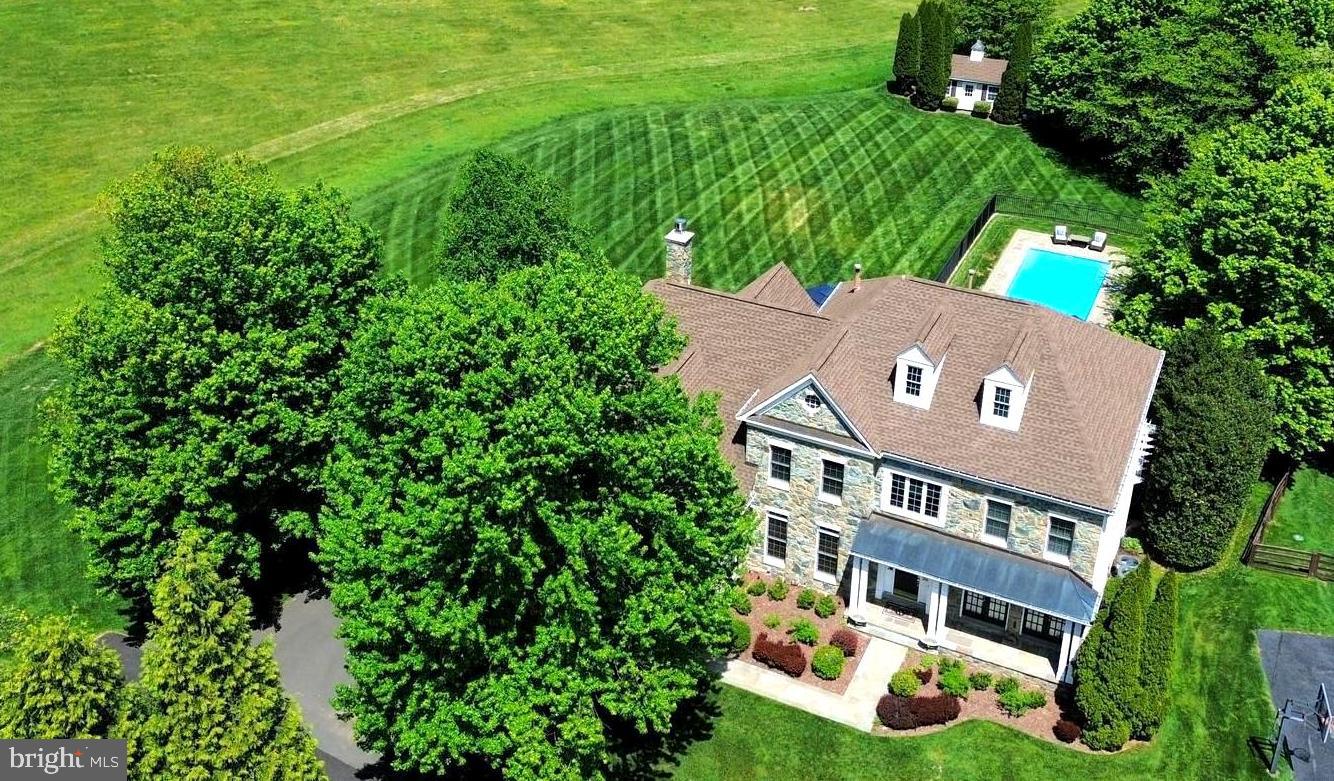 Set on one of the most coveted and private homesites in Lenah Run, this estate home offers a rare combination of privacy, scale, and refined outdoor living with beautiful decks, flagstone patios and an inviting pool!  Over 6,000 square feet of interior living space offers plenty of room to entertain. 

Privately positioned at the end of a quiet cul-de-sac, this residence is sited on one of the community’s most picturesque lots, backing to protected conservation land and offering a serene, uninterrupted natural backdrop.  A handsome stone exterior, paired with a covered front porch featuring a standing seam metal roof and flagstone entry, introduces the home with timeless architectural presence.  The outdoor living experience is exceptional. Thoughtfully designed for both intimate relaxation and large-scale entertaining, the property features multiple elevated decks, expansive flagstone terraces, and a beautiful pool—all overlooking beautifully landscaped grounds and the surrounding conservation area. The result is a setting of remarkable privacy and quiet sophistication.

Inside, a light-filled two-story foyer sets the tone, complemented by a flowing floor plan designed for both everyday living and formal entertaining with over 6,000 square feet. A private main-level library offers an ideal work-from-home environment, while the formal living and dining rooms provide refined spaces for hosting while providing serene views.  The gourmet kitchen is appointed with high-end finishes, including Sub-Zero & GE Monogram appliances, a walk-in pantry, recessed lighting and solid wood cabinetry, and opens up to a sunroom wrapped in windows - capturing sweeping views of the pool and natural landscape beyond. The adjacent two-story family room features a wood-burning fireplace and  dramatic wall of windows to take in the views.  

The upper level is anchored by a spacious primary suite with a private sitting area and dual walk-in closets, along with a well-appointed bath featuring separate vanities, a soaking tub, separate shower, and enclosed water closet.  A large princess suite offers its own ensuite bathroom and walk-in closet, while two additional generously sized bedrooms share an additional third full bath upstairs. 

The walk-out lower level offers a blank canvas and flexibility to create your perfect informal living spaces—whether a media room or fitness studio, plus an additional fifth bedroom with 4th full bath—while still maintaining generous open recreation space with a wet-bar rough-in.  

Walk out to your private flagstone patio with arbor covering, or take a dip in your private saltwater pool with flagstone patio.   This original-owner home has been impeccably maintained, and offers recent replacements include a new roof (2018), 3 new HVAC (2021), newer high-end kitchen appliances, new pool pump (2023). 

Homes with this combination of setting, privacy, and outdoor living are a rare find along the Rt. 50 corridor.  Prime homesites are becoming more rare.  Why settle for a home that backs up to other homes or a busy road?  Create lasting memories with family and friends in a home and setting that will awe and inspire you and your guests each time you arrive home.