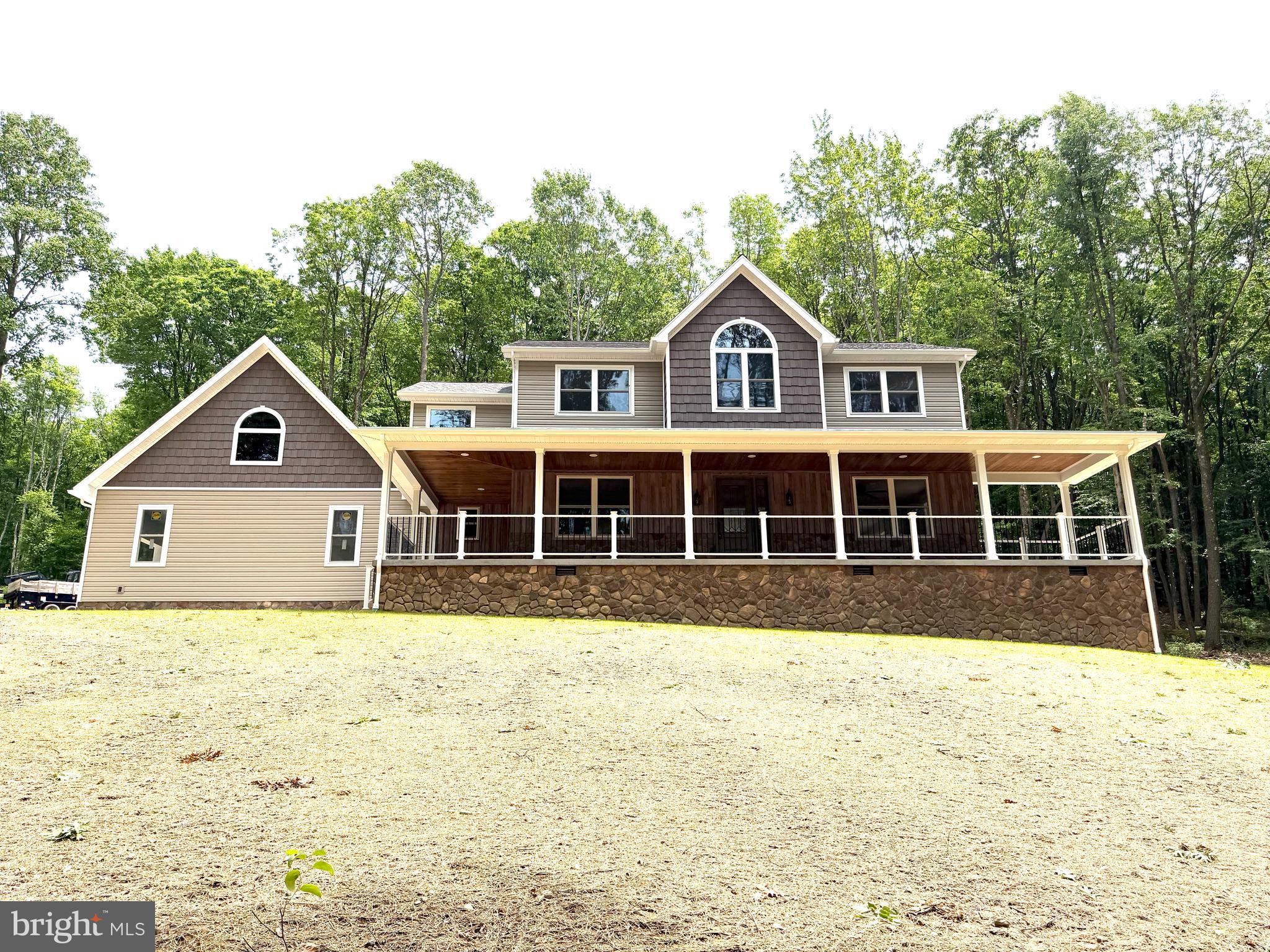 NEW CONSTRUCTION (additional photos to follow) - Exquisitely built custom home on 1.77+/- acres. This 3,000+/- square foot home with expansive outdoor entertaining areas gives you the best of country living in close proximity to town. No expense has been spared in this meticulously thought out home. From the time you enter onto the covered porch and into the vaulted ceiling entryway, you will feel the spaciousness, yet warmth this home has to offer. With four bedrooms and three and one half baths and an open floor plan, there is plenty of room to enjoy this finely appointed home. The hickory hardwood and ceramic tiled floors throughout this home offer continuity between the three levels of living space. The kitchen boasts custom-made, painted cabinetry with solid surface countertops and a center island for additional work and storage space. The upper level of the home has three generously sized bedrooms each with custom built-in dressers and plenty of closet space. The primary bedroom features an on-suite with a spacious floor-to-ceiling custom shower and a soaking tub along with a expansive closet complete with floor to ceiling custom cabinetry and shelving. The finished basement has its own entryway and offers an additional bedroom with full bath, a complete kitchen and entertainment space enhancing the livable square footage of this tremendous home. The attached two car garage offers plenty of space for vehicles and additional storage space including a bonus room above the garage. The quiet, gently sloping, wooded lot offers privacy to enjoy your morning coffee on the covered front porch or an evening meal on the expansive back patio. If you are ready for luxurious living in a peaceful, country setting, this is the property to make this dream a reality.  Located 7+/- miles to Morgantown, WV. 14+/- miles to Kingwood, WV. 26+/- miles to Fairmont, WV.