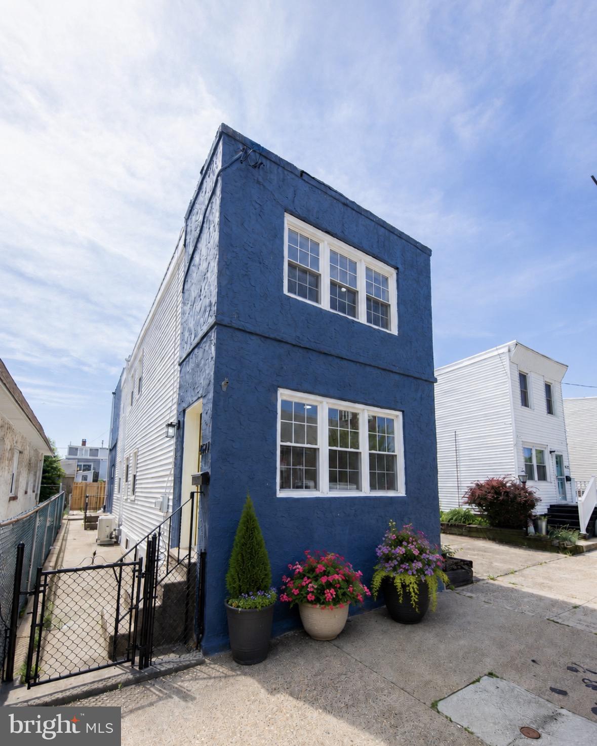 Nestled in the heart of Bridesburg, here is a rare single home with a two-car driveway! Step inside to a welcoming foyer with built-in cubbies, perfect for stashing those school bags. The first floor is fully updated, featuring a sleek half bath with a new vanity and chic half-tiled walls. The living area features recessed lighting, and everything—from drywall to flooring—is fresh and modern. The brand-new kitchen dazzles with quartz countertops, gold hardware, a gooseneck faucet, and stylish cabinetry. Sliding glass doors lead to a spacious backyard, perfect for entertaining, followed by your two-car driveway. The custom black steel railing leads to three spacious bedrooms. The full bath upstairs is a showstopper, with a floor-to-ceiling tiled shower, luxurious gold fixtures, and a separate soaking tub. The large basement is perfect to add living space, laundry area, and plenty of storage. Enjoy peace of mind knowing that you have a new roof, HVAC system, water heater, electric panel, windows, and doors! Move right in and enjoy all these new updates. Time to schedule your showing!