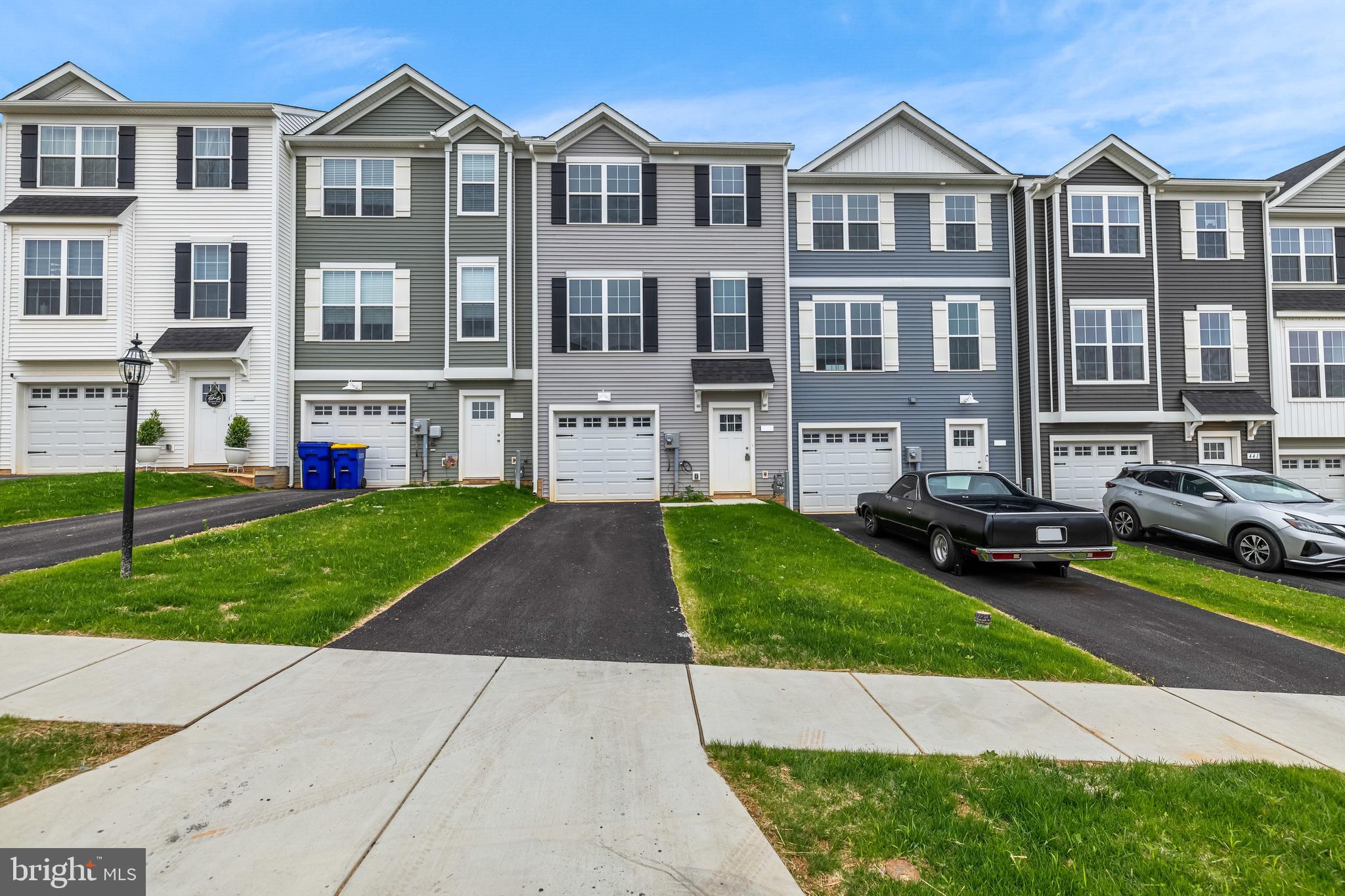 $5,000 in incentives* Welcome home to 456 Bradford Dr in Red Lion PA! Located in the Hudson Ridge community within the Dallastown Area School District, this newly constructed interior townhome offers approximately 1,900 square feet of modern living space with quick move-in opportunities available, as well as additional to-be-built options. Designed with a bright, open layout and 9+ foot ceilings throughout, this 4 bedroom, 3.5 bath home combines functionality, natural light and contemporary finishes in a convenient location. The main living level features an open floor plan connecting the kitchen, dining and living areas. The kitchen is equipped with granite countertops, an island, built-in range and microwave, stainless steel appliances including a dishwasher, and upgraded lighting fixtures throughout the kitchen and dining space. Sliding glass doors off the dining area provide access to an optional rear deck, while a conveniently located half bath completes the level. Luxury vinyl plank flooring runs throughout the first and second floors, enhancing the clean and modern design. Upstairs, the spacious primary suite features cathedral ceilings, ceiling fan, large walk-in closet and a private bath with a walk-in shower. Two additional bedrooms with carpet flooring and a shared full bath complete the third floor. The entry level includes a fourth bedroom with an attached full bath, offering flexibility for guests, office space or multigenerational living, along with interior access to the attached one-car garage. Conveniently located near Route 24, Route 74 and I-83, with easy access to York, Baltimore, Red Lion and surrounding commuter areas. Close to shopping, dining and everyday conveniences while offering low-maintenance new construction living. Schedule your private tour today!
