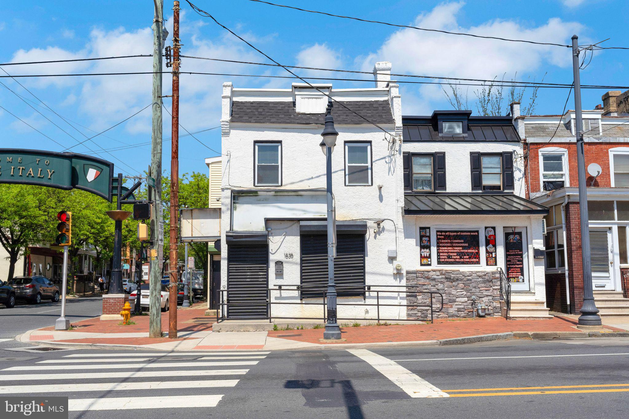 Welcome to Little Italy, on the West side of the City of Wilmington!  Probably one of the most well known intersections in all its glory, the Little Italy archway that greets and leads you down the road to the hot spot restaurants that Wilmington has to offer.  Commercially zoned, mixed use, corner property is available for its next custodian.  Store front on the main level could host a plethora of uses and features a wide open interior, multiple restrooms, plus various areas that can be utilized in a constructive manner depending on your needs.  Basement area for storage is easily accessed from the store front and has restrooms as well.  Some ideas to get your imagination jump started; pharmacy, restaurant, convenience store, pawn shop, check cashing, vape shop, place of worship, or my personal favorite - Marijuana Dispensary.  Second level features a custom fit out, two bedroom apartment that has private access to a rear roof top area for relaxing as the warmer months make their presence felt.  Main bedroom with vaulted ceiling and ensuite bathroom with tile and custom shower stall.  Kitchen with gray shaker cabinetry, topped with granite, an island for additional seating and food preparation area complete with stainless under mount sink.  Full bath services main living space and rear bedroom is draped in tile and other custom accouterments.  Excellent opportunity to live above your business, purchase and rent both units for cash flow, or operate a business and rent the apartment for additional income.  Excellent location on heavily traveled artery into and out of downtown Wilmington on a lighted intersection gives extreme exposure for pedestrians and vehicle traffic alike.  Bring your vision and make this your center of operation!