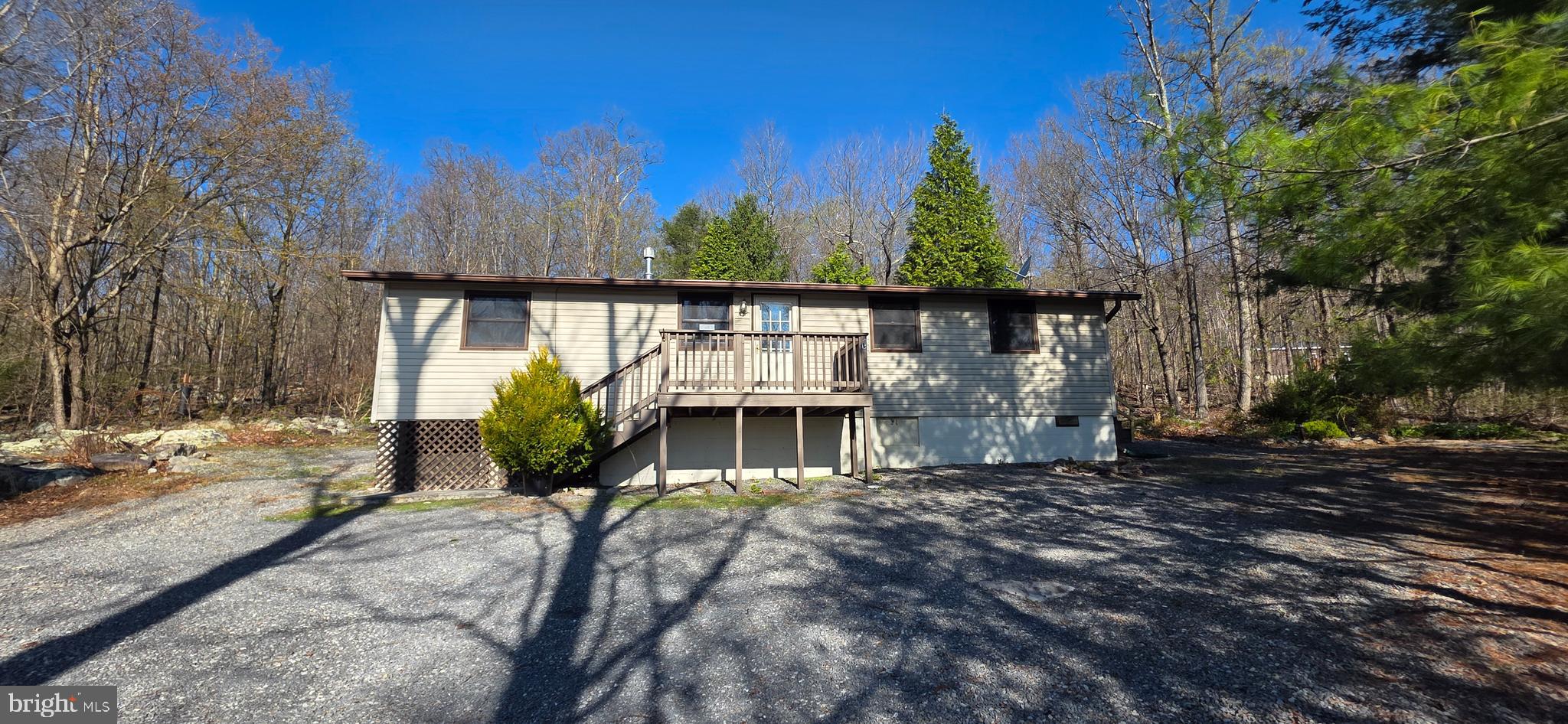 Nestled in the serene Shawneeland community, this charming ranch-style home offers a perfect blend of comfort and tranquility. Set on a generous 1.92-acre lot, the property features a gently sloping landscape adorned with mature trees, creating a peaceful retreat from the hustle and bustle of everyday life. This 3-bedroom, 1-bathroom home invites you to unwind and make lasting memories. The detached garage provides ample storage and parking, while the off-street parking ensures convenience for you and your guests. Enjoy the benefits of rural living with easy access to nature trails and outdoor activities, making it an ideal spot for those who appreciate the beauty of the great outdoors.  Experience the charm and potential of this delightful property today!
