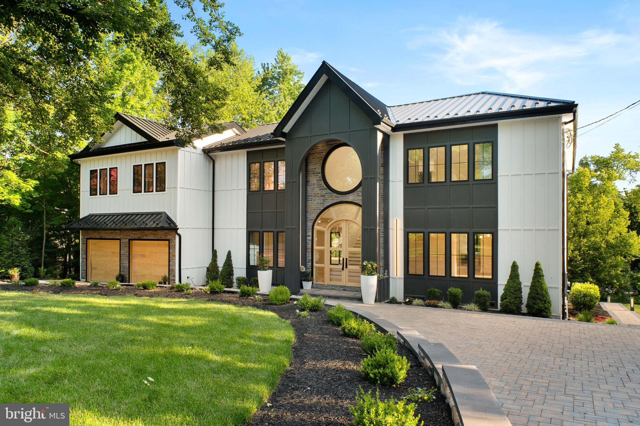 A rare opportunity to own a truly exceptional custom residence where architectural excellence, cutting edge construction, and sophisticated design come together to create an extraordinary living experience. This newly built estate has been thoughtfully conceived for those who appreciate uncompromising quality, timeless craftsmanship, and the ability to personalize a home to reflect their individual lifestyle.

From the moment you arrive, the attention to detail is unmistakable. Private smart entry gates open to an elegant paver drive and walkways that lead to a striking entrance designed to make a lasting impression. The home's exterior combines enduring beauty with superior performance, featuring premium fiber cement siding and a standing seam metal roof engineered for longevity, energy efficiency, and year round protection from the elements.

Inside, soaring spaces and refined finishes create an atmosphere that is both grand and welcoming. A dramatic two story foyer serves as the centerpiece of the home, highlighted by a custom crafted white oak entry system and walls of oversized windows that fill the interior with natural light. Throughout the main level, ten foot ceilings enhance the sense of openness while showcasing the home's exceptional scale and design.

Designed for both everyday living and memorable entertaining, the expansive floor plan offers an effortless flow between living spaces. At the heart of the home is a spectacular chef's kitchen featuring premium finishes, abundant workspace, and a layout designed to accommodate intimate family gatherings as well as large scale entertaining. Adjacent living and dining spaces seamlessly connect to the outdoors through expansive glass doors that open to an impressive 2,000 square foot deck, creating a natural extension of the home's entertaining areas.

The residence offers four luxurious bedroom suites, each thoughtfully designed with a private bathroom to provide comfort, privacy, and convenience for family and guests. An additional flex room offers endless possibilities as a home office, library, media room, or creative space.

The primary suite serves as a private sanctuary unlike any other. Featuring soaring cathedral ceilings and an indulgent spa inspired bathroom, the space has been designed to rival the finest luxury resorts. Dual glass enclosed showers, a freestanding soaking tub, sauna, multiple skylights, and expansive custom walk in closets create an atmosphere dedicated to relaxation and rejuvenation.

The partially finished lower level adds approximately 1,700 square feet of versatile space ready to accommodate a home theater, fitness studio, game room, wine cellar, or additional living area. Every element has been carefully considered to maximize both functionality and enjoyment.

Even the garage has been elevated beyond expectations. Featuring custom hardwood doors, smart technology, twelve foot ceilings, and its own dedicated climate control system, this space is ideal for car enthusiasts, hobbyists, or those seeking additional flexibility.

Built with a focus on efficiency, durability, and modern convenience, the home incorporates advanced systems and premium materials designed to provide peace of mind for years to come. The result is a residence that delivers both exceptional beauty and lasting value.

Set within one of Chestnut Hill's most desirable locations, this remarkable property offers a rare blend of custom luxury, modern innovation, and timeless elegance, creating an unparalleled place to call home.
