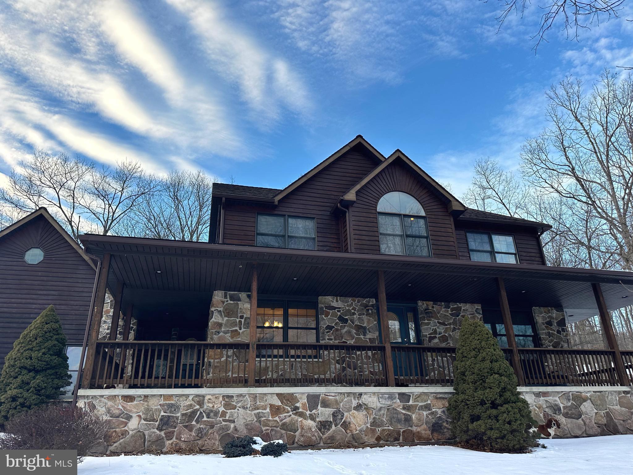 Welcome to 761 Timberlake! The perfect place to call home in the mountains of Wild, Wonderful West Virginia. This stunning cedar and stone home sits on a little over 3 acres, includes a fenced in back yard, a pond for swimming, fishing or floating, beautiful scenery and plenty of space for the whole family. 
This home has 3 bedrooms, 2.5 bathrooms, main level laundry, a finished basement, a theater room, office space and space for everything!!  The master bedroom has its' own full bathroom with a jacuzzi tub.  The kitchen has stainless appliances, ceramic tile and granite countertops. There is a stone fireplace in the living room which creates a cozy atmosphere, or you can step outside to the patio with a bar, stone fireplace and hot tub. This is your chance to own a piece of mountain paradise.